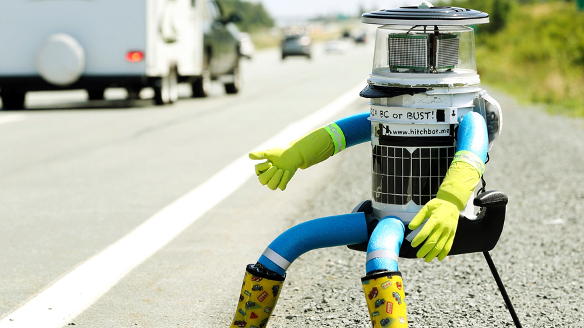 File photo - The anthropomorphic robot named hitchBOT sits on the shoulder of Highway 102 outside of Halifax, Nova Scotia, July 27, 2014.