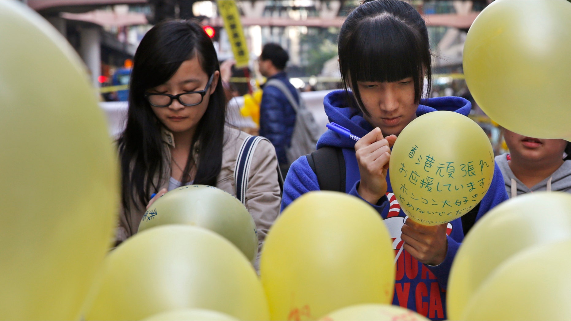 Dec. 13, 2014: People write their support messages on the balloon in the Causeway Bay shopping district, one of the occupied areas in Hong Kong.