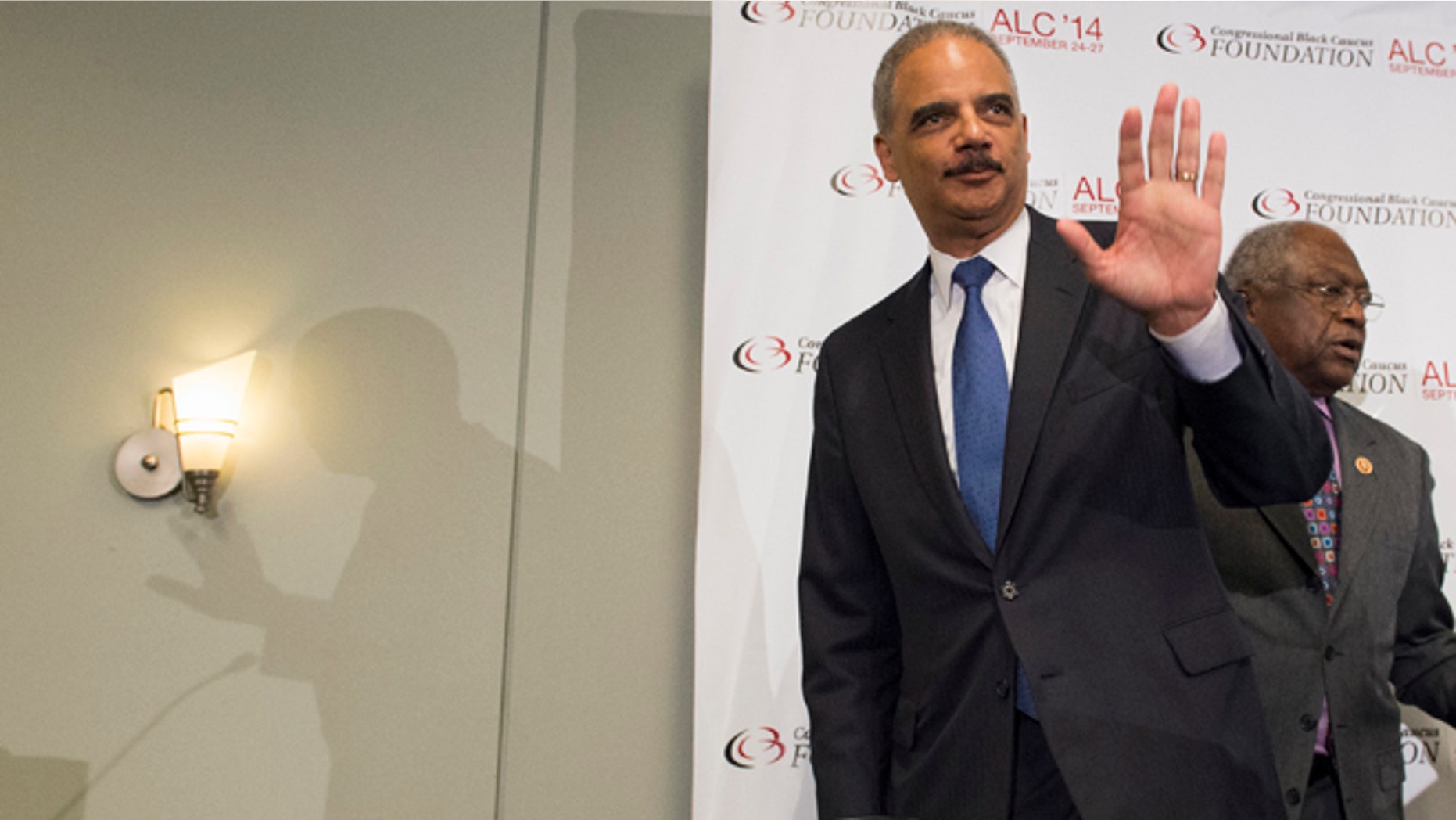 In this Friday, Sept. 26 photo, outgoing Attorney General Eric Holder waves at the Voting Rights Brain Trust event, during the 2014 Congressional Black Caucus Annual Legislative Conference in Washington.