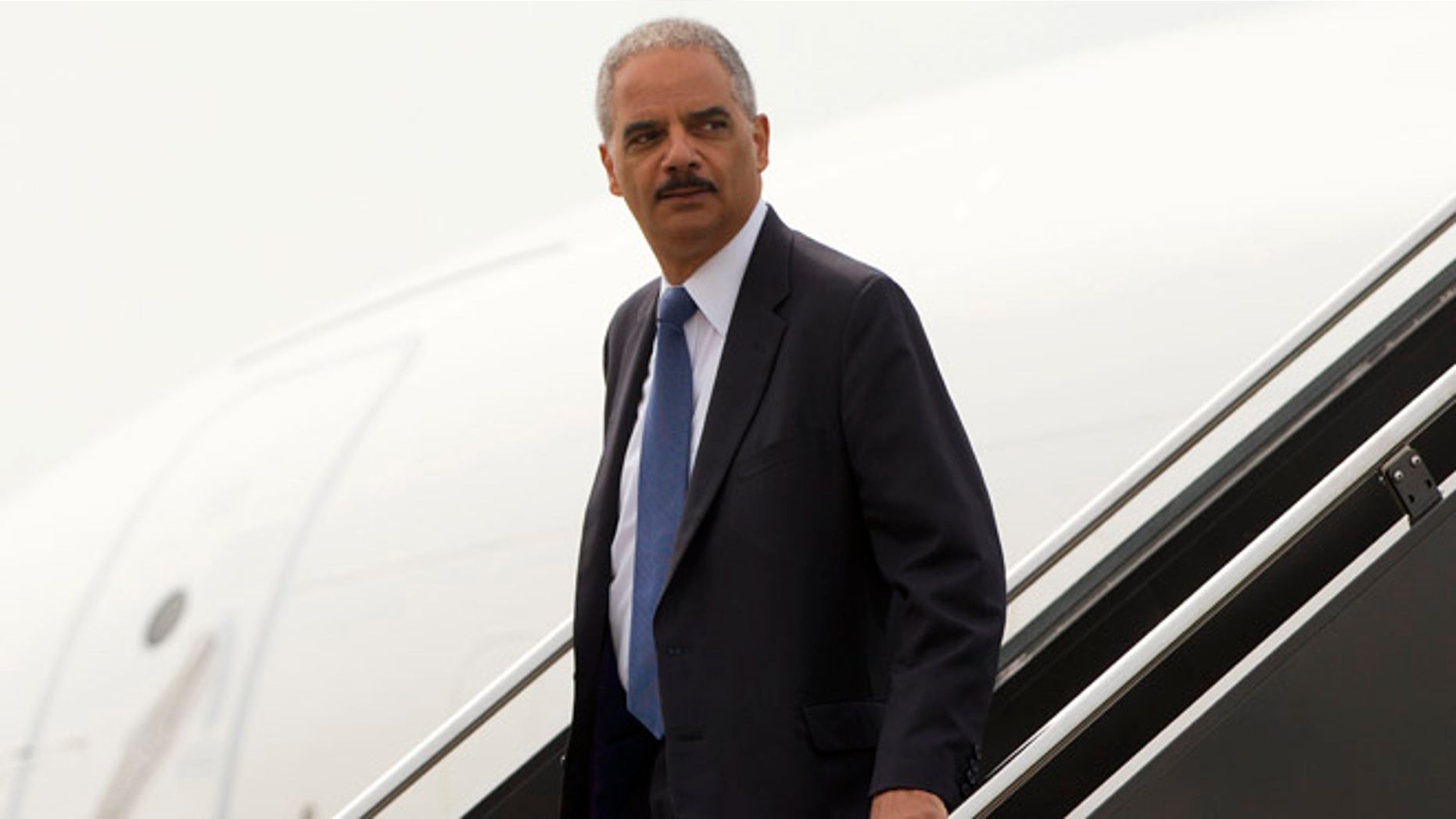 Attorney General Eric Holder arrives on US Military aircraft at Lambert-St. Louis International Airport in St. Louis, Wednesday, Aug. 20, 2014.