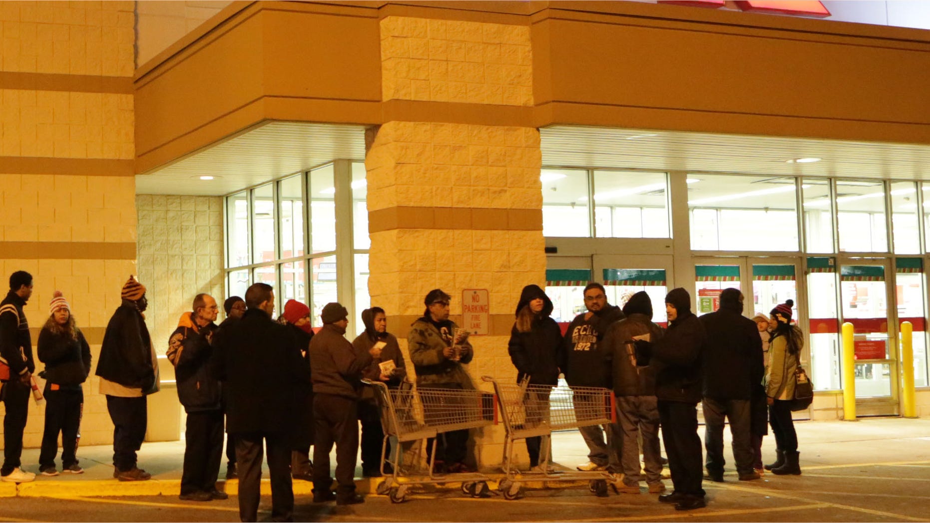 Nov. 27, 2014: Customers line up outside a Kmart store on Thanksgiving morning in Chicago, Ill.