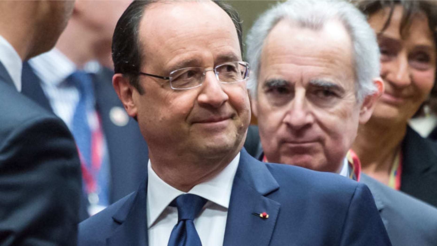 March 6, 2014: French President Francois Hollande, center, speaks with Ukraine's Prime Minister Arseniy Yatsenyuk, left, during a round table meeting at an EU summit in Brussels.