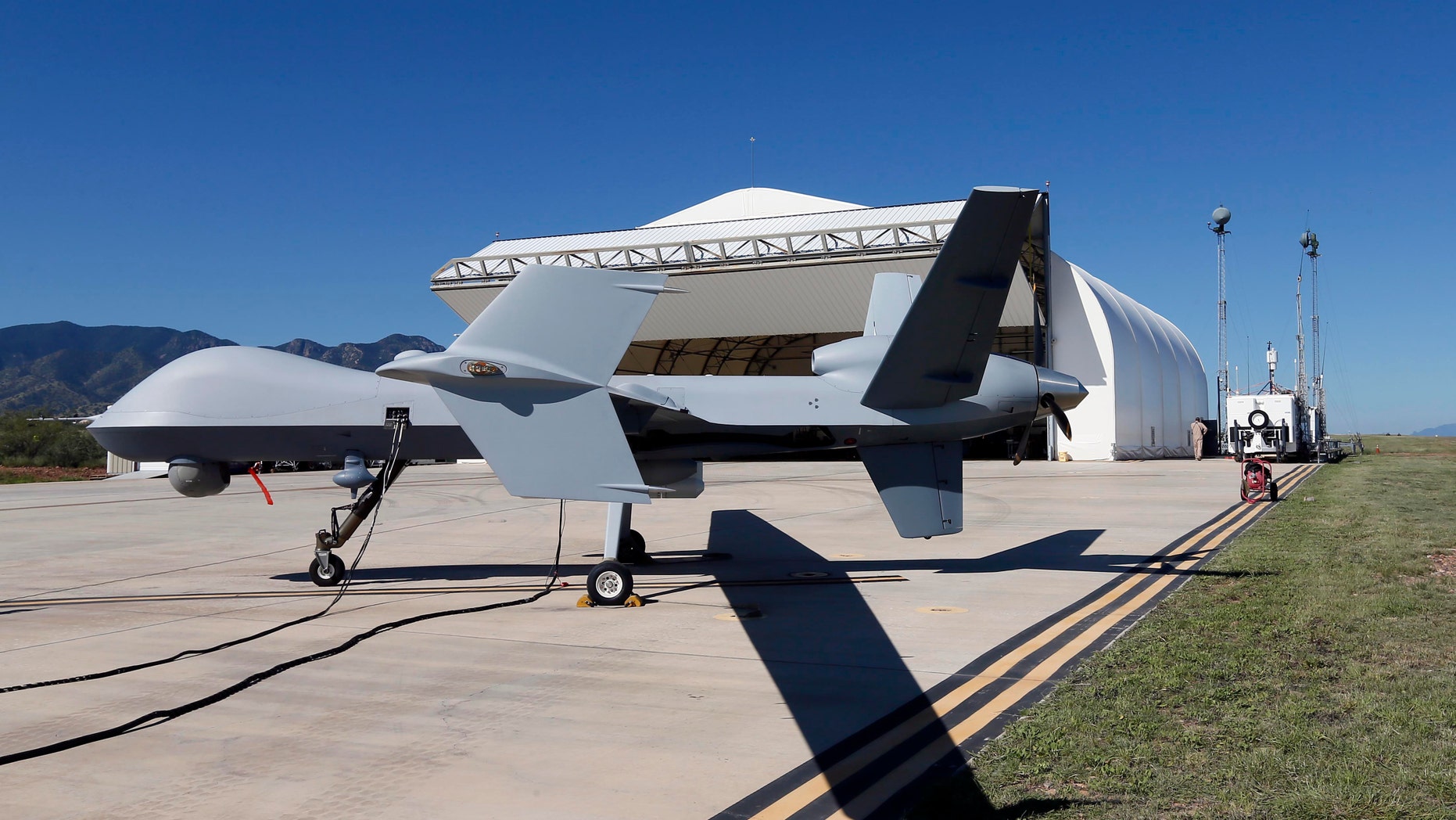 FILE - In this Sept. 24, 2014 file photo, a U.S. Customs and Border Patrol drone aircraft is prepped prior to it's flight at Ft. Huachuca in Sierra Vista, Ariz. The Homeland Security Department's border drones program costs far more than the government estimates, helps in the arrests of just a fraction of the number of people trying to cross the border illegally and flies far fewer hours than the government claims, an internal watchdog asserted in a report released Tuesday. Inspector General John Roth said in his report that the Predator B drones flown along the border by Customs and Border Protection are "dubious achievers." (AP Photo/Matt York, File)