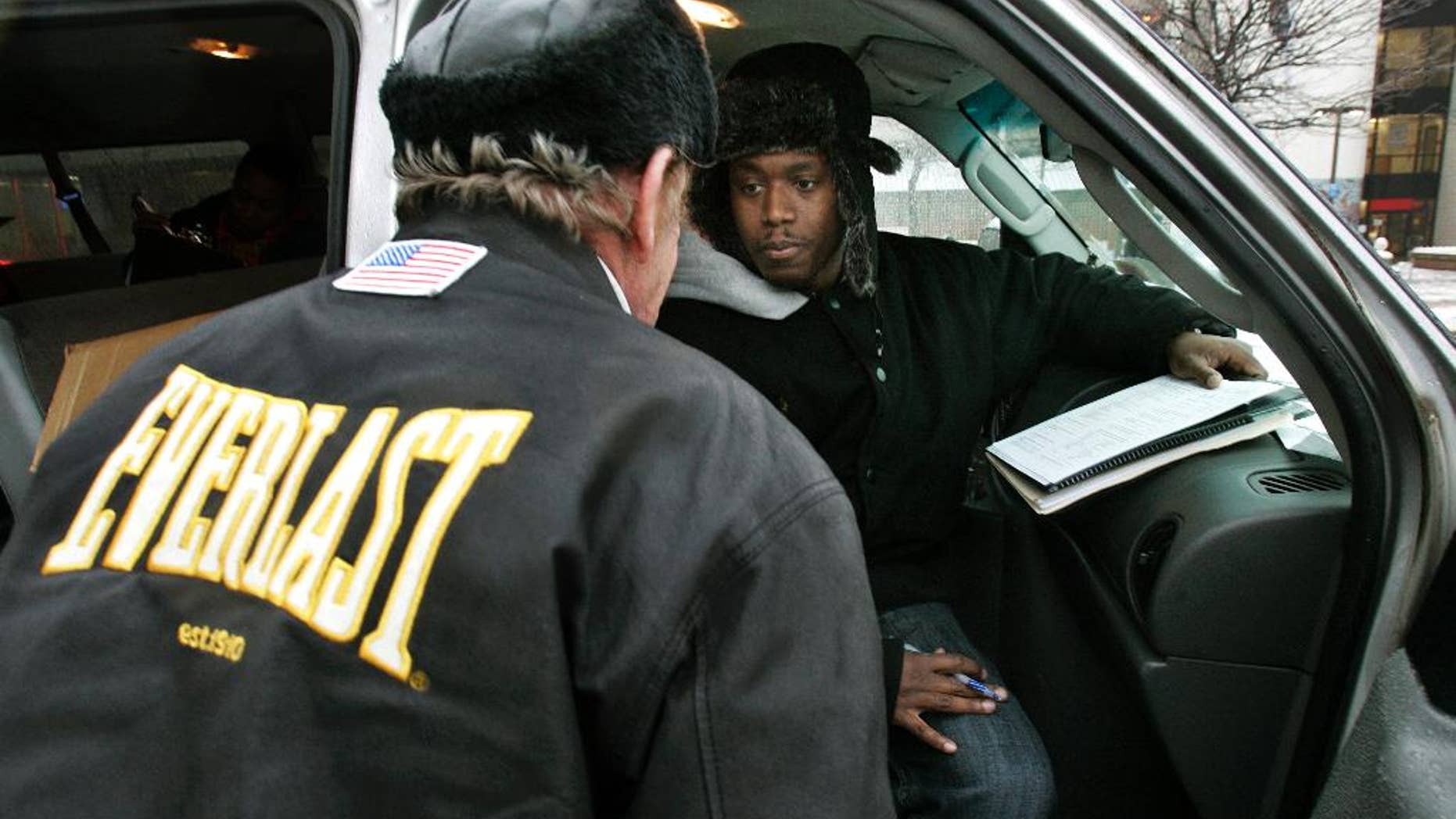 FILE - In this Wednesday, Jan. 28, 2009 file photo, Harold "Hal" Miller, right, listens to a homeless man while preparing census forms for homeless people in Camden, N.J. Miller, well known in Camden for working with the city's homeless population, has been arrested and charged with running a drug market in the city. In an indictment dated Sept. 1, federal authorities say 38-year-old Harold "Hal" Miller ran an operation that sold heroin and crack on Pfeiffer Street in East Camden. (AP Photo/Mel Evans, File)