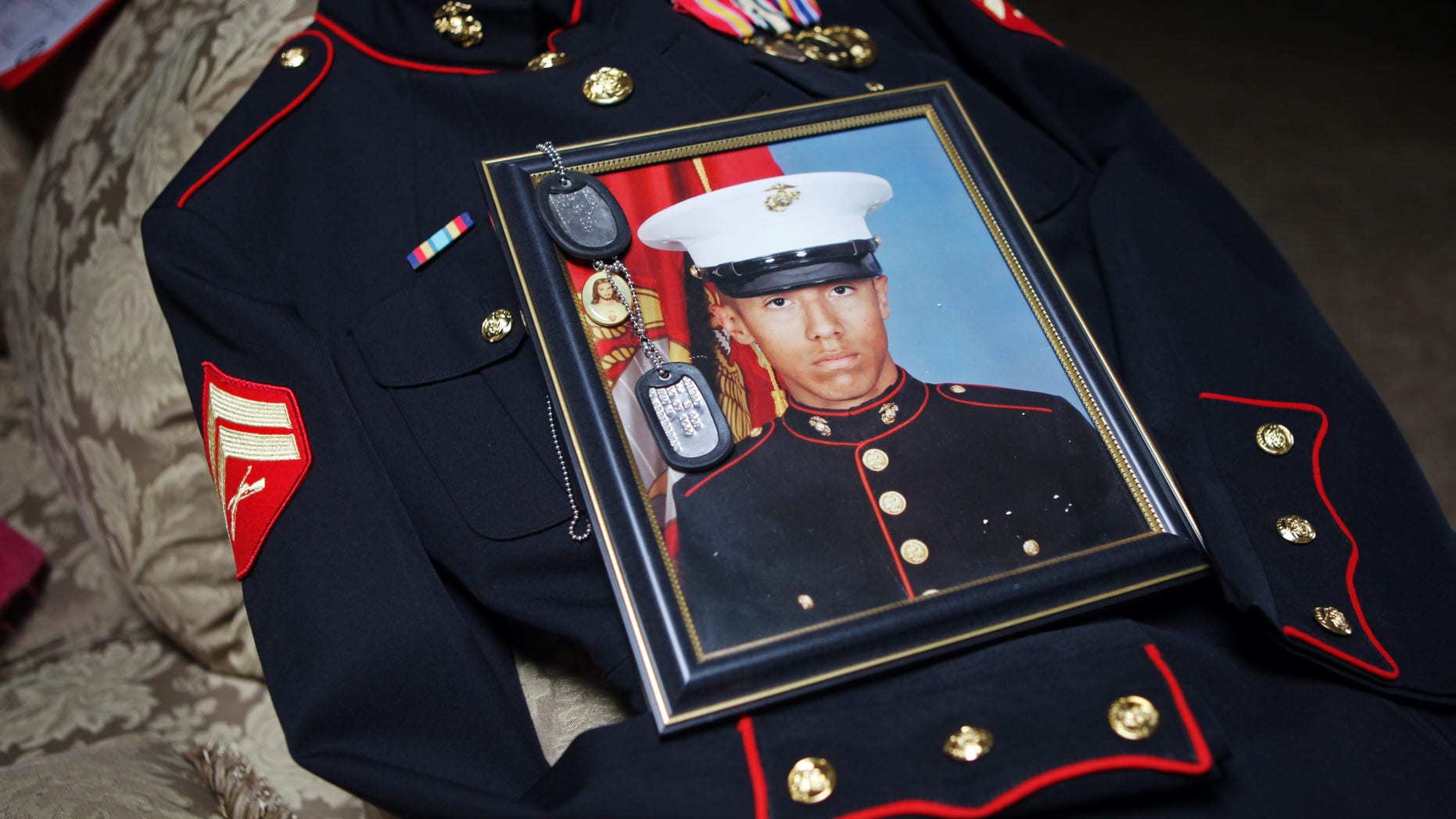 January 15: Itzcoatl Ocampo’s dress uniform, government military photo, dog tags and a religious medallion that went to war with him lie on display at Ocampo’s home in Yorba Linda, California.