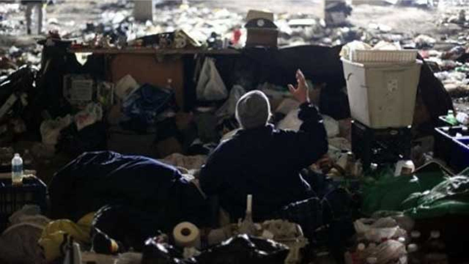 A homeless veteran who declined to be identified speaks with an outreach worker, not pictured, under an overpass during a winter storm in Philadelphia, Wednesday, Jan. 26, 2011. A code blue alert for severe weather has been issued by the city to encourage and sometimes compel the homeless to seek shelter.
