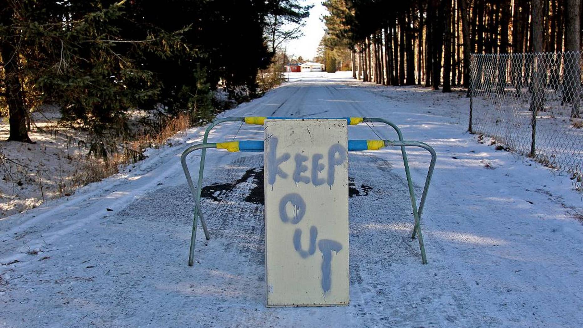 FILE - In this Nov. 26, 2012 file photo, a keep out sign stands at the property of Byron David Smith, in Little Falls, Minn. The Little Falls man who claimed he was defending his home from teens who had been terrorizing him for months goes on trial Monday, April 14, 2014, for their murders. (AP Photo/The Star Tribune, Elizabeth Flores) MANDATORY CREDIT; ST. PAUL PIONEER PRESS OUT; MAGS OUT; TWIN CITIES TV OUT