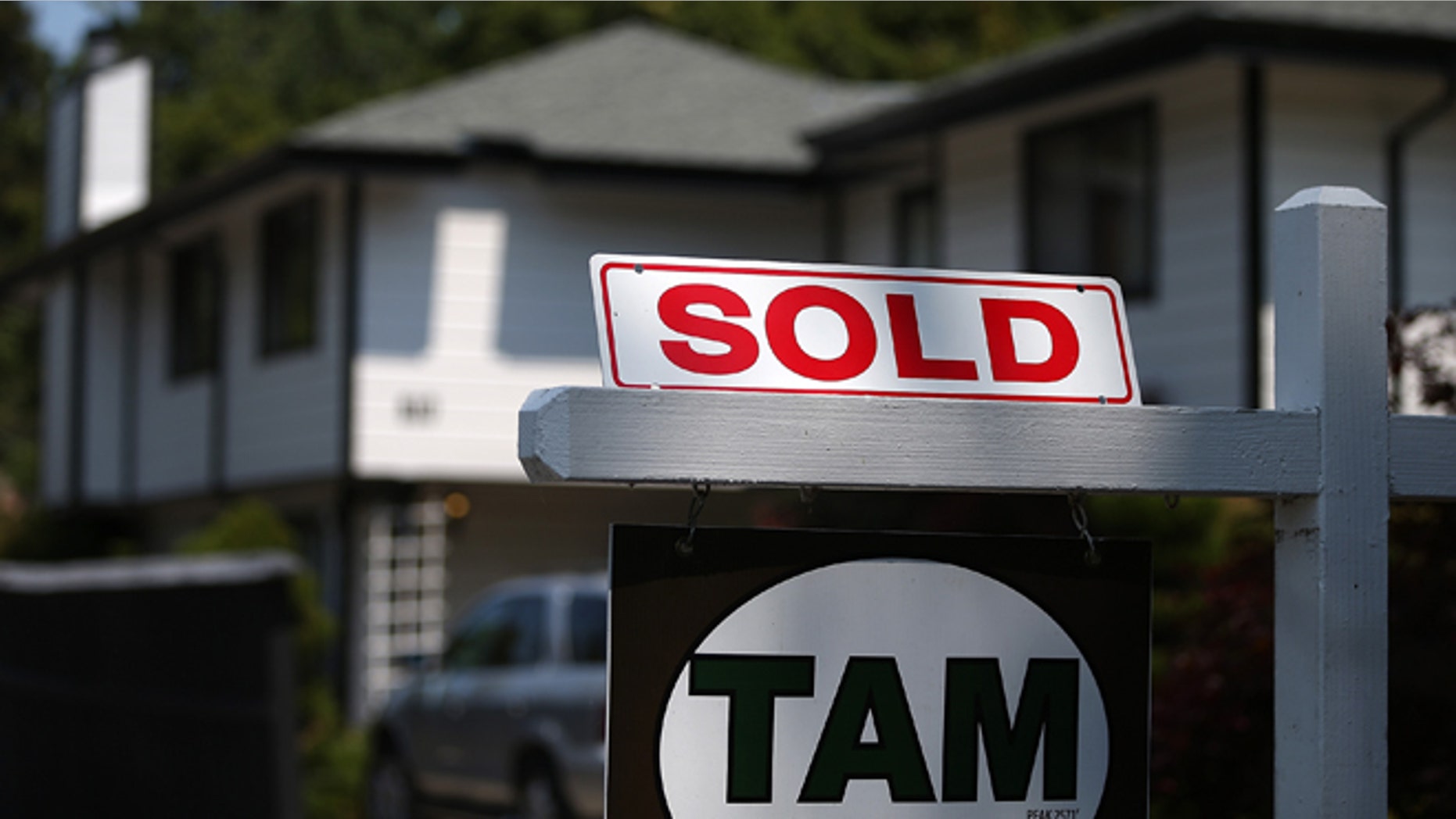 SAN ANSELMO, CA - JULY 02: A sold sign is posted in front of a home for sale on July 2, 2013 in San Anselmo, California. According to a report by real estate data provider CoreLogic, home prices in the U.S. surged 12.2 percent in May compared to a year ago, the largest increase in seven years. (Photo by Justin Sullivan/Getty Images)