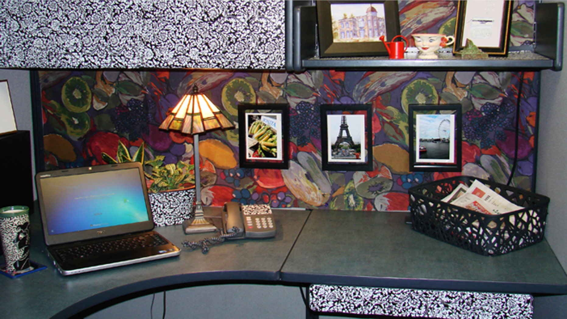 Feb. 25, 2013: Following the expert advice of several interior designers, this cubicle at a Thornton, Colo., business was styled using a bold fabric pattern on the facing cubicle wall and black-and-white patterned contact paper on an upper cabinet and various accessories.