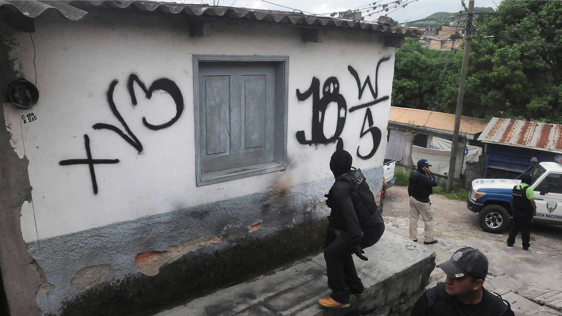 In this June 14, 2012 photo, national police recover a home that had been seized by gangs in the 14 de Marzo neighborhood in Tegucigalpa, Honduras. (AP Photo/Fernando Antonio)