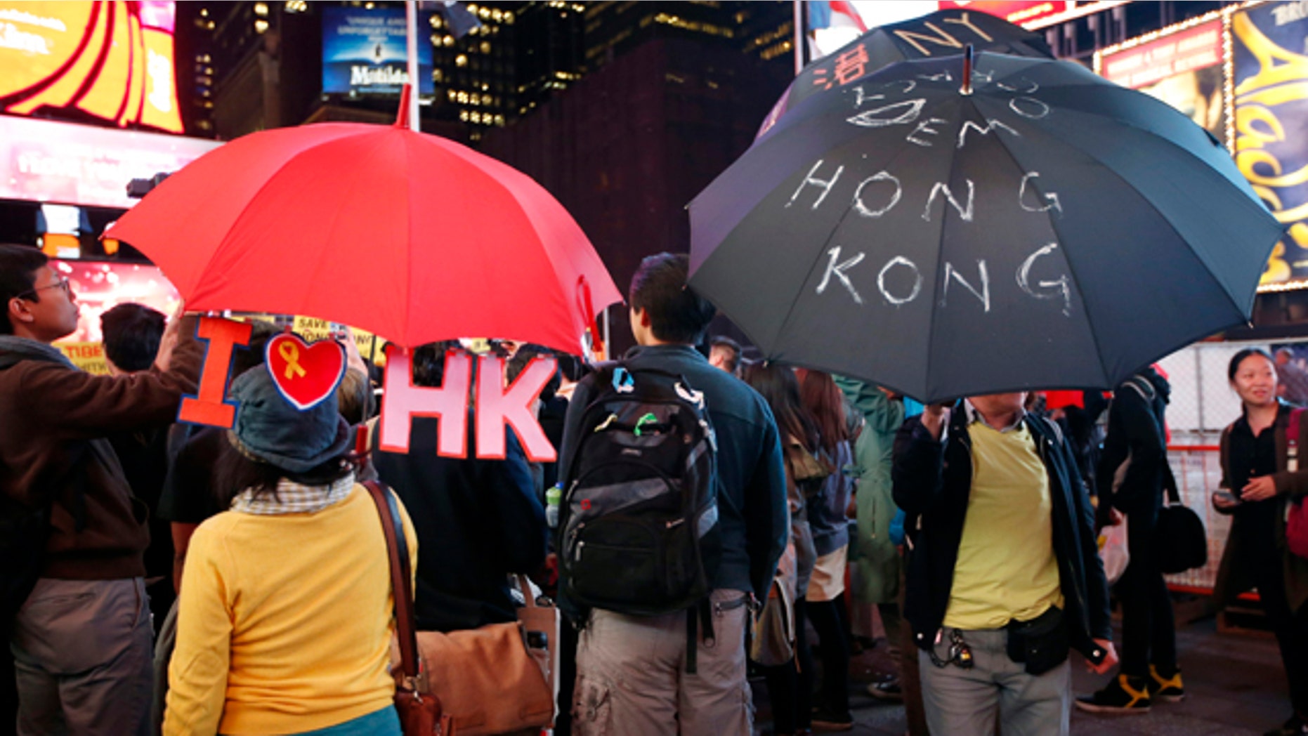 October 1, 2014: People hold up customized umbrellas during a rally in New York's Times Square. Students bearing umbrellas as a sign of solidarity gathered at rallies in several U.S. cities to show support for pro-democracy protesters in Hong Kong. (AP Photo/Kathy Willens)