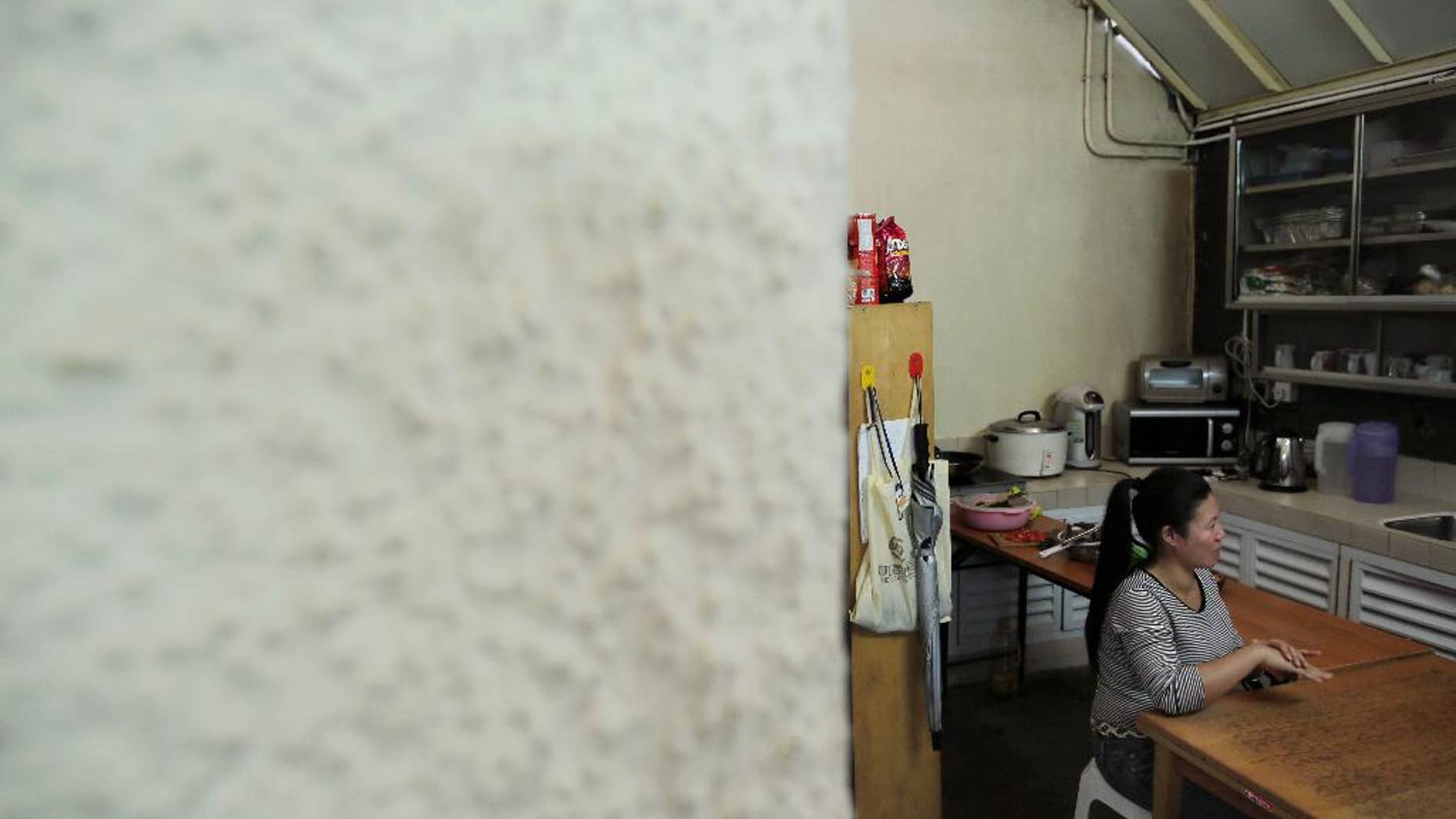 A Filipino domestic worker, who asked to be identified only by her first name, Babylen, speaks during an interview with The Associated Press at a shelter opened for unemployed domestic workers in Hong Kong Friday, Nov. 7, 2014. More than 160,000 Indonesians, almost all women, have taken similarly perilous routes to jobs as maids, nannies and housekeepers in Hong Kong, lured by salaries as much as five times higher than at home. Now, they’re mourning two of their own Seneng Mujiasih and Sumarti Ningsih, former domestic workers in their 20s who were found stabbed to death last weekend in the luxury apartment of British investment banker Rurik George Caton Jutting. For Babylen the past year and a half in Hong Kong has been a bitter disappointment. An injury on the job led to her dismissal in March. Now, she’s waiting to receive compensation while sleeping in the shelter. (AP Photo/Vincent Yu)