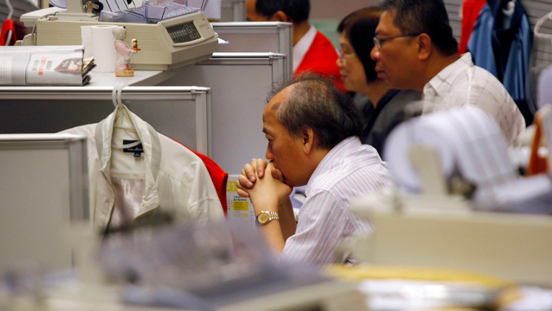 Aug. 9, 2011: A trader reacts at the Hong Kong Stock Exchange in Hong Kong in the morning session.