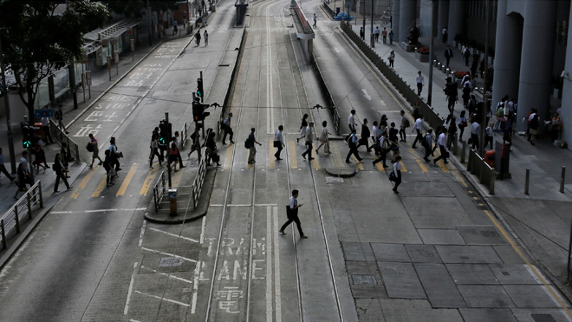 Oct. 9: People walk to work in the occupied areas at Central district in Hong Kong.