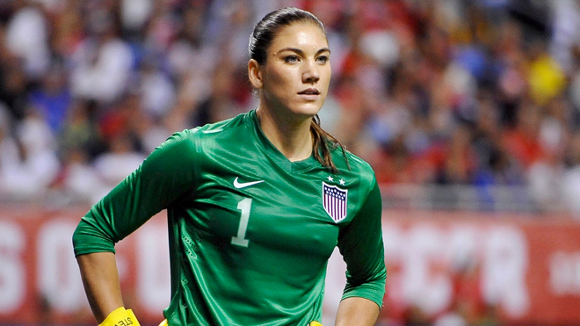 FILE - In this Oct. 20, 2013, file photo, United States goalkeeper Hope Solo pauses on the field during the second half of an international friendly women's soccer match against Australia in San Antonio. U.S. Soccer is standing by its decision to allow goalkeeper Hope Solo to continue to play while she faces domestic violence charges, Tuesday, Sept. 23, 2014. (AP Photo/Darren Abate, File)