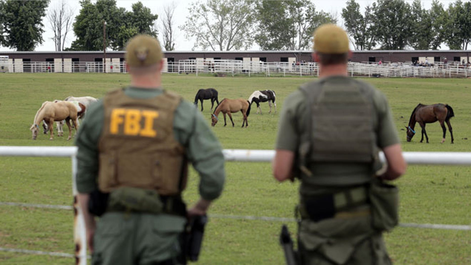June 12, 2012: FBI agents overlook a horse ranch under investigation in Lexington, Okla. Federal agents raided the Oklahoma ranch and a prominent quarter horse track in New Mexico on Tuesday, alleging the brother of a high-ranking official in a Mexican drug cartel used a horse-breeding operation to launder money.