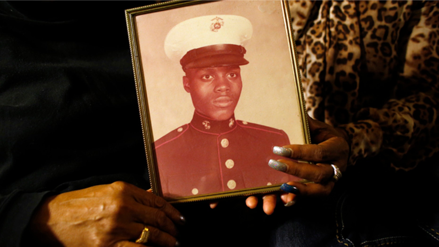 March 12, 2014: A photo of Jerome Murdough is held by his mother and sister in the Queens, New York. Murdough, a 56-year-old mentally ill inmate at Rikers Island jail, "baked" to death in his overheated cell during one of the coldest recorded winters in city history.