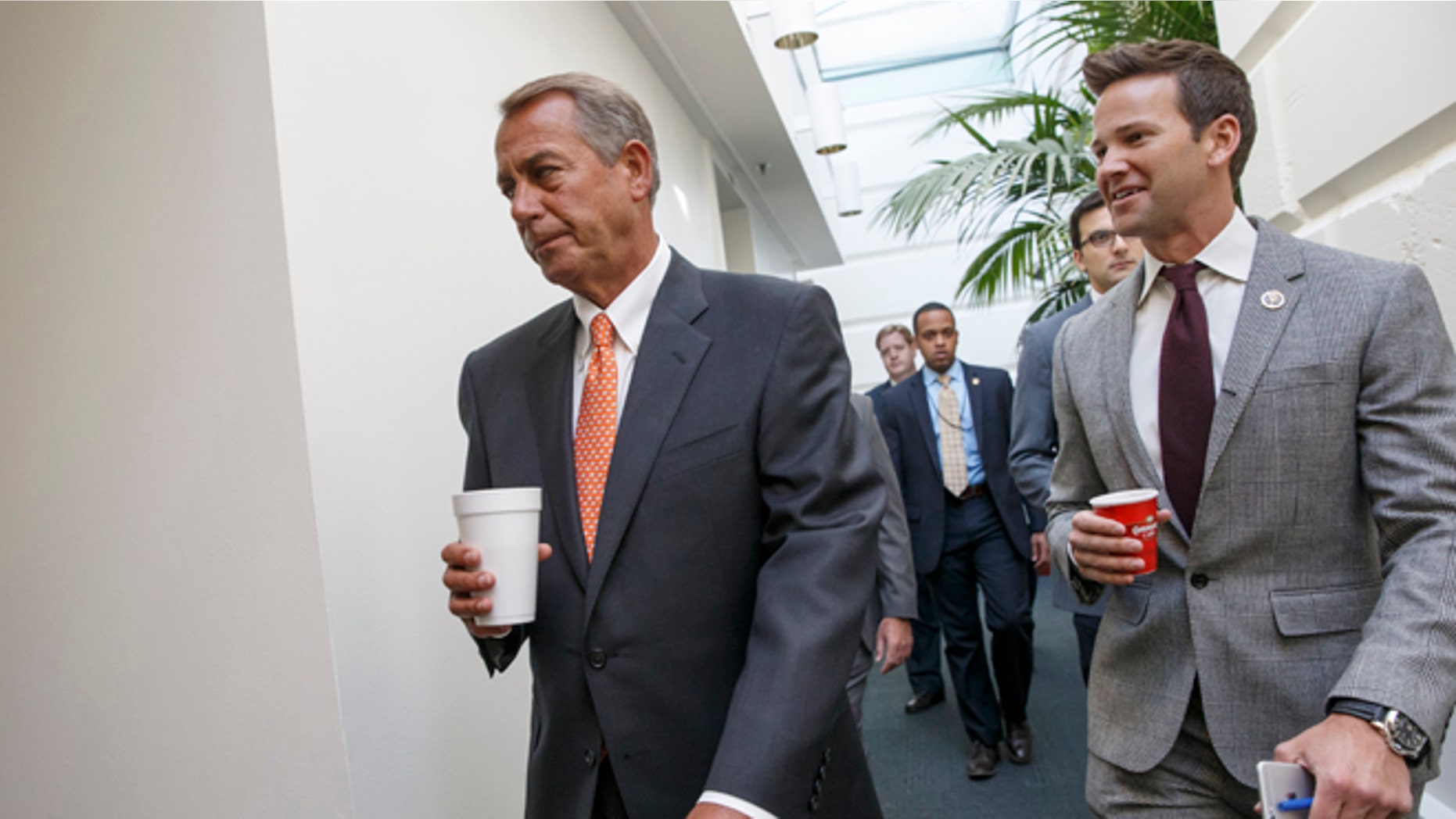 House Speaker John Boehner of Ohio walks with Rep. Aaron Schock, R-Ill., as House Republicans head to a closed-door meeting on thwarting President Barack Obama's executive actions on immigration by blocking the funding for the Department of Homeland Security. Friday, Jan. 9, 2015, on Capitol Hill in Washington. Obama's directives in November gave temporary relief from deportation to about 4 million immigrants in the country illegally, along with permits allowing them to work legally in the U.S. His move infuriated Republicans after their midterm election victories, and they vowed to retaliate once they assumed full control of Congress this week. (AP Photo/J. Scott Applewhite)
