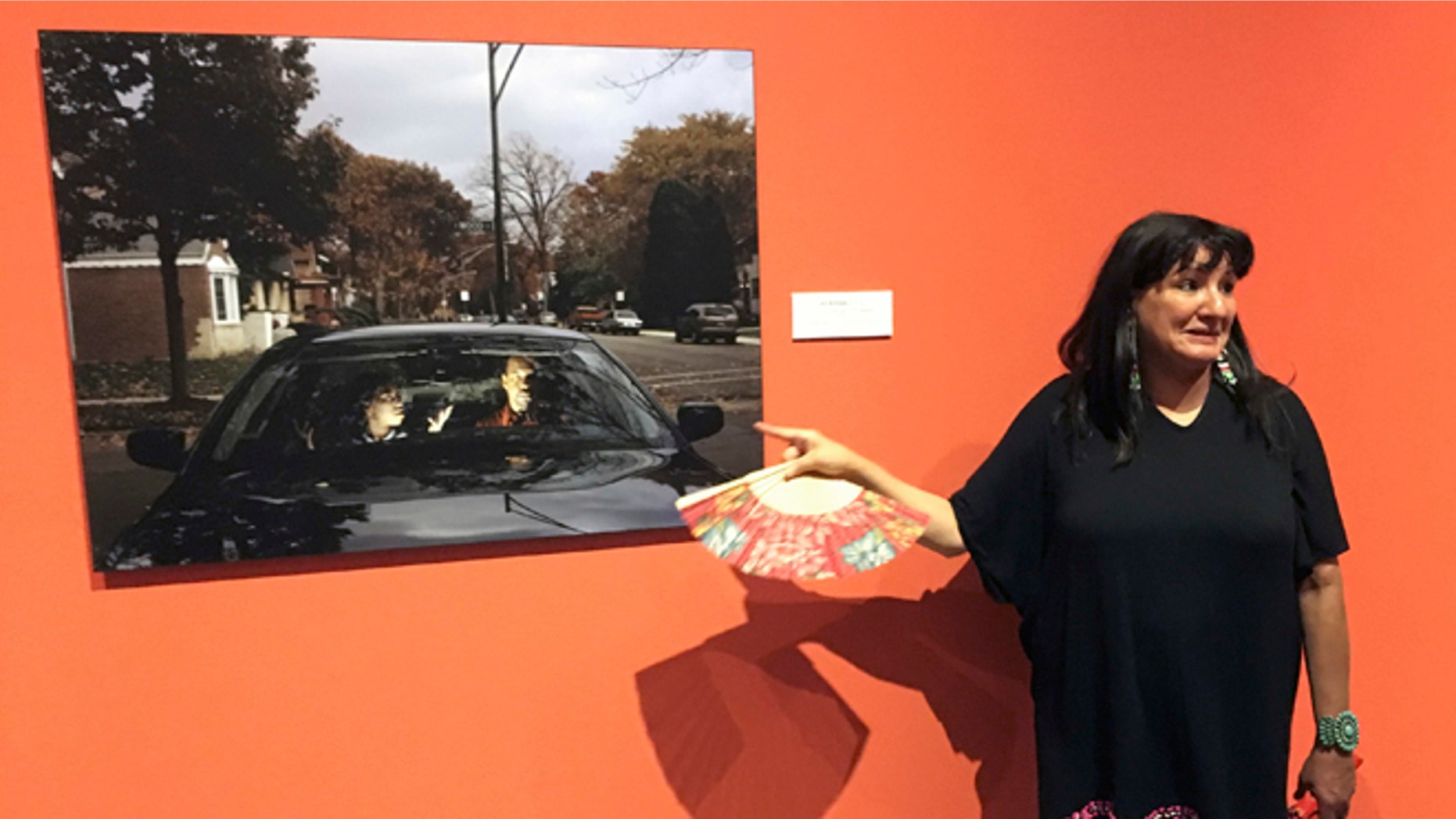 This Wednesday, July 27, 2016 photo acclaimed Mexican-American author Sandra Cisneros points to a photograph by Cecil McDonald, Jr., at the National Hispanic Cultural Center in Albuquerque, N.M. at an exhibit based by her 1984 novel "The House of Mango Street." The exhibit "The House on Mango Street: Artists Interpret Community" features major themes of the novel of a Mexican-American girl coming of age in Chicago. (AP Photo/Russell Contreras)