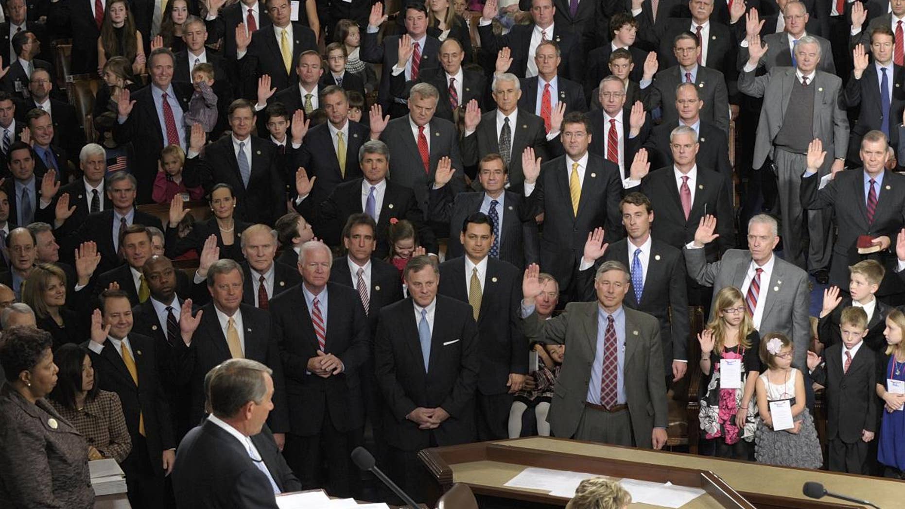 House Speaker John Boehner of Ohio delivers the oath of office to members of the House of Representatives during the first session of the 112th Congress, on Capitol Hill in Washington, Wednesday, Jan. 5, 2011. (AP Photo/Susan Walsh)
