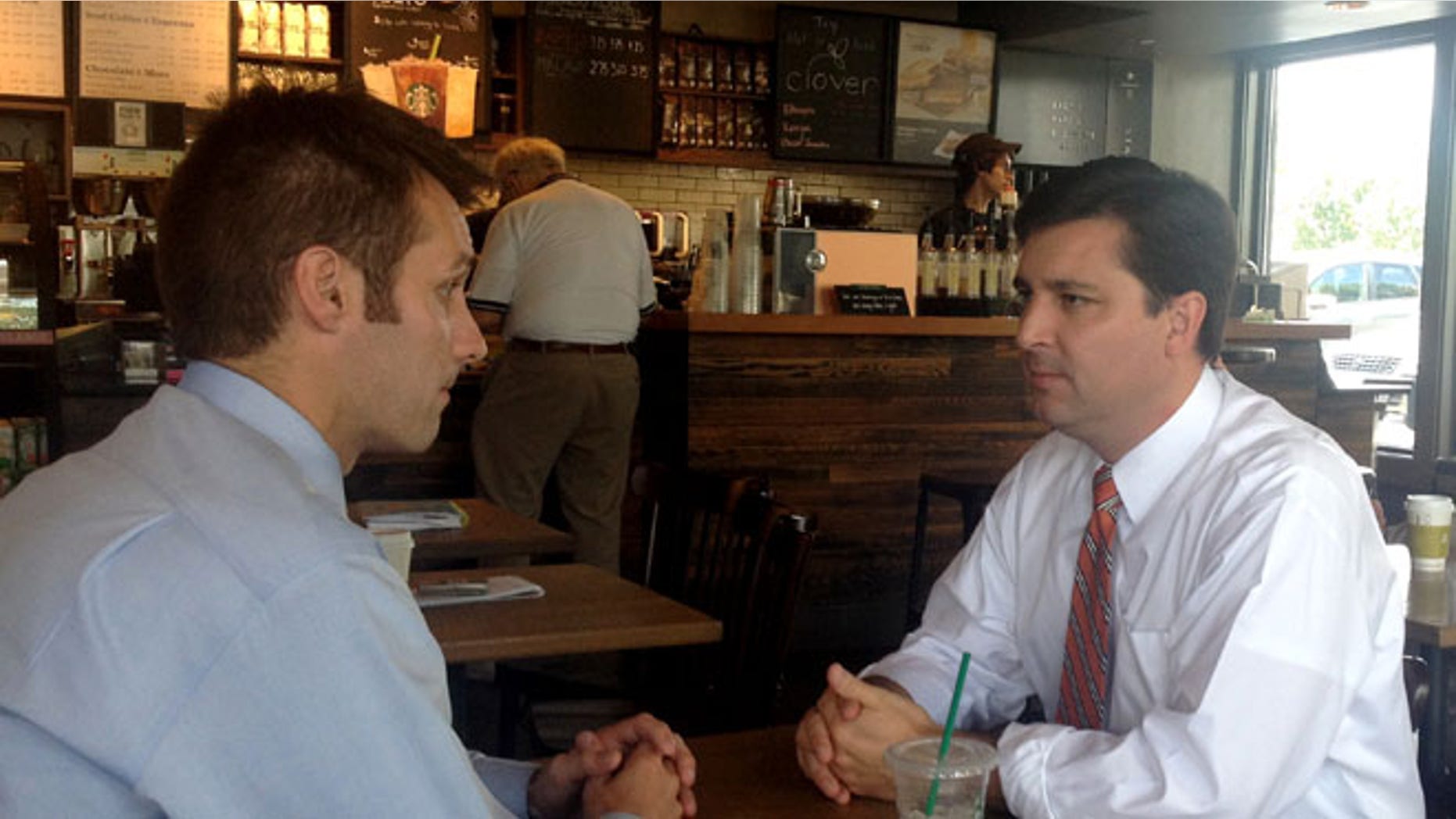 FILE: June 30, 2014: North Carolina Republican House candidate David Rouzer, right, talking with a campaign aide, in Raleigh, N.C.