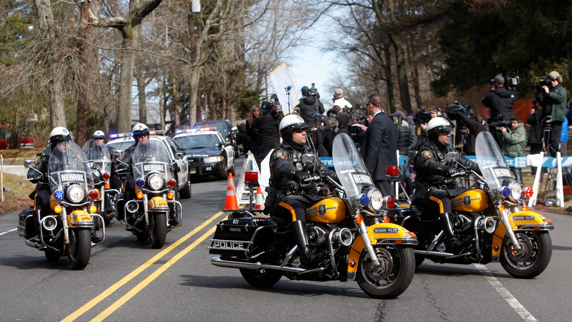 A Newark Police Department motorcade escorts the hearse carrying the body of Whitney Houston arrives at Fairview Cemetery for her burial in Westfield, N.J., on Sunday. (AP Photo/Rich Schultz)