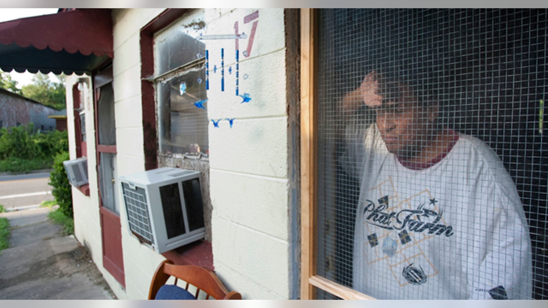 July 11: Tomas Rodriguez stands in his doorway next door to the apartment where Houston police say 34-year-old Alex Duncan is accused in the death of his visiting 6-year-old son after the boy allegedly was beaten for not falling asleep in Houston. (AP)