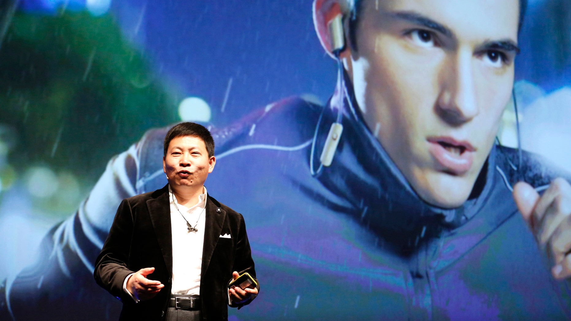 Huawei Chief Executive Richard Yu presents the TalkBand N1 during a news conference in Barcelona March 1, 2015.
