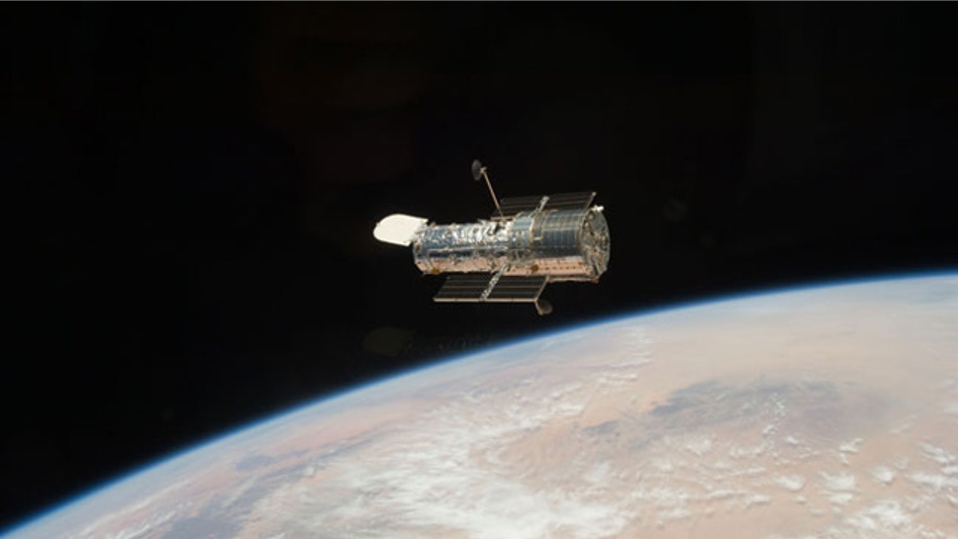 The Hubble Space Telescope, seen here in orbit above the Earth, after it was released from the shuttle Atlantis at the close of the STS-125 servicing mission in May 2009.