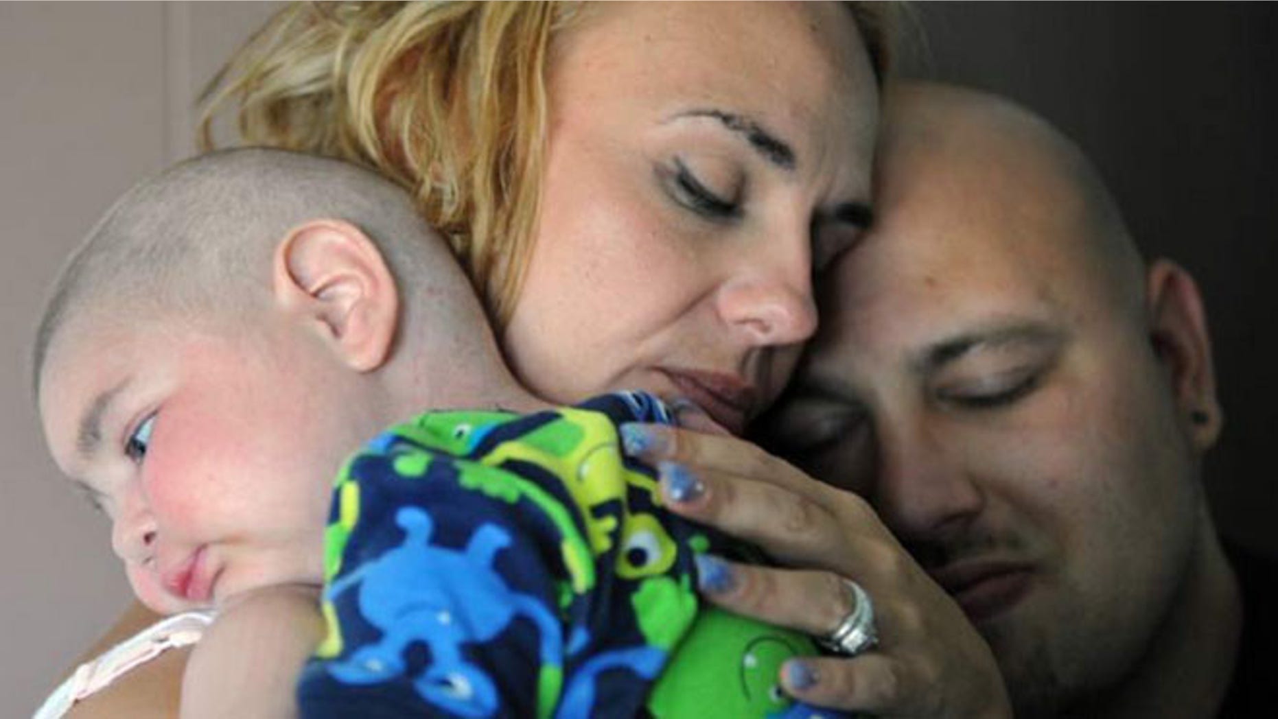 July 30: Christine Swidorsky holds her son, Logan Stevenson, 2, with her husband-to-be and Logan's father, Sean Stevenson