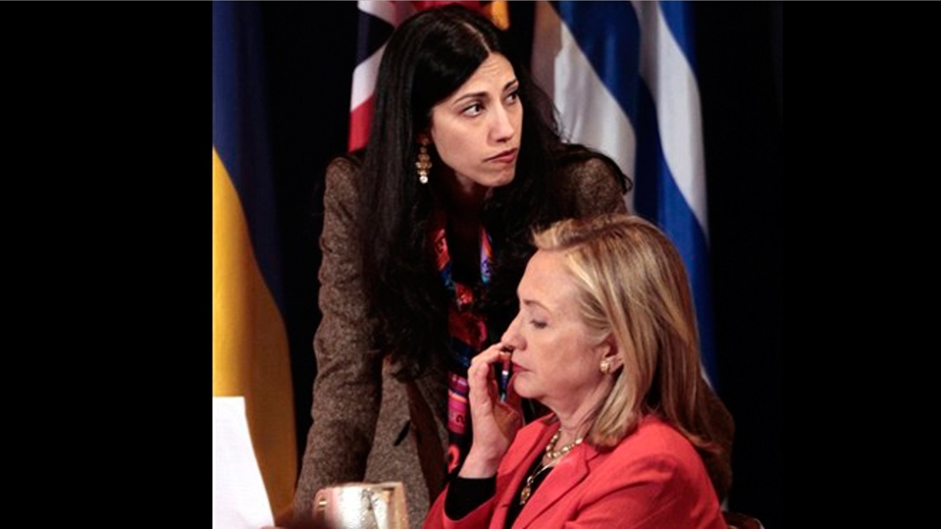 In this Sept. 20, 2011 file photo, Huma Abedin, top, deputy chief of staff and aide to Secretary of State Hillary Rodham Clinton, right, during a meeting with leaders for the Open Government Partnership in New York.