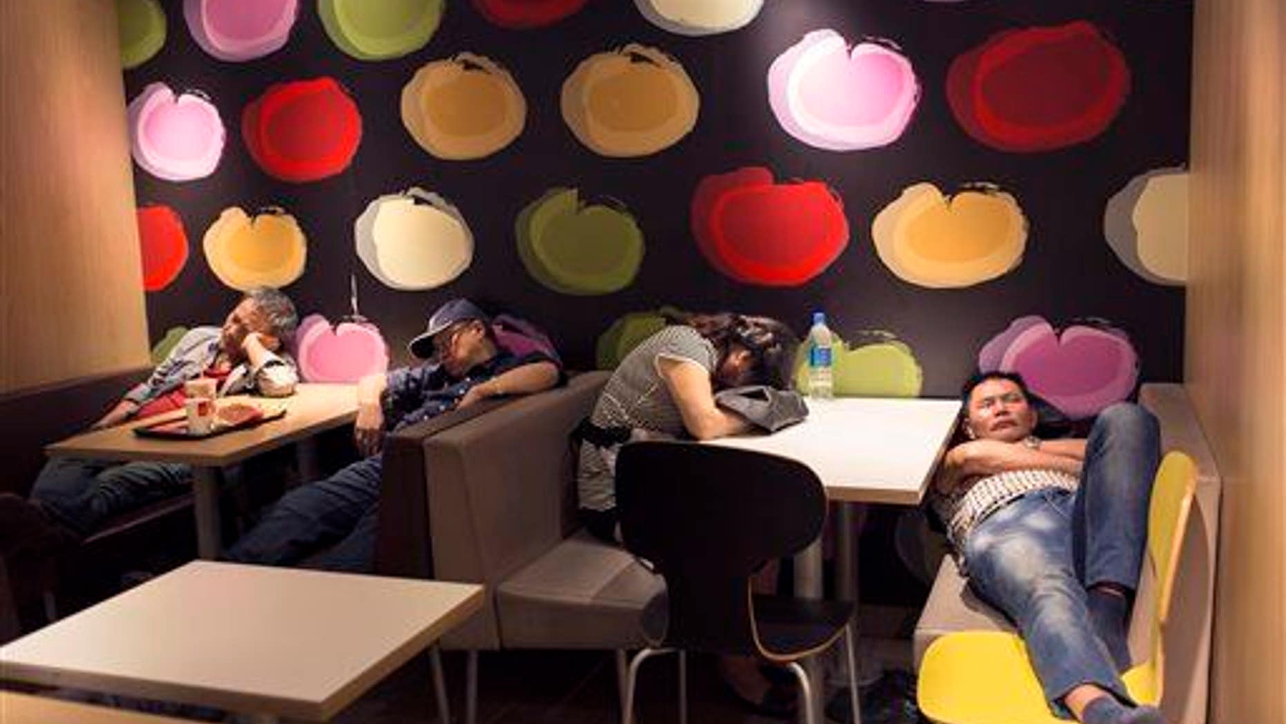 A group of people sleep in a 24-hour McDonald���s in Hong Kong. A new study found humans are more efficient sleepers than our primate ancestors.