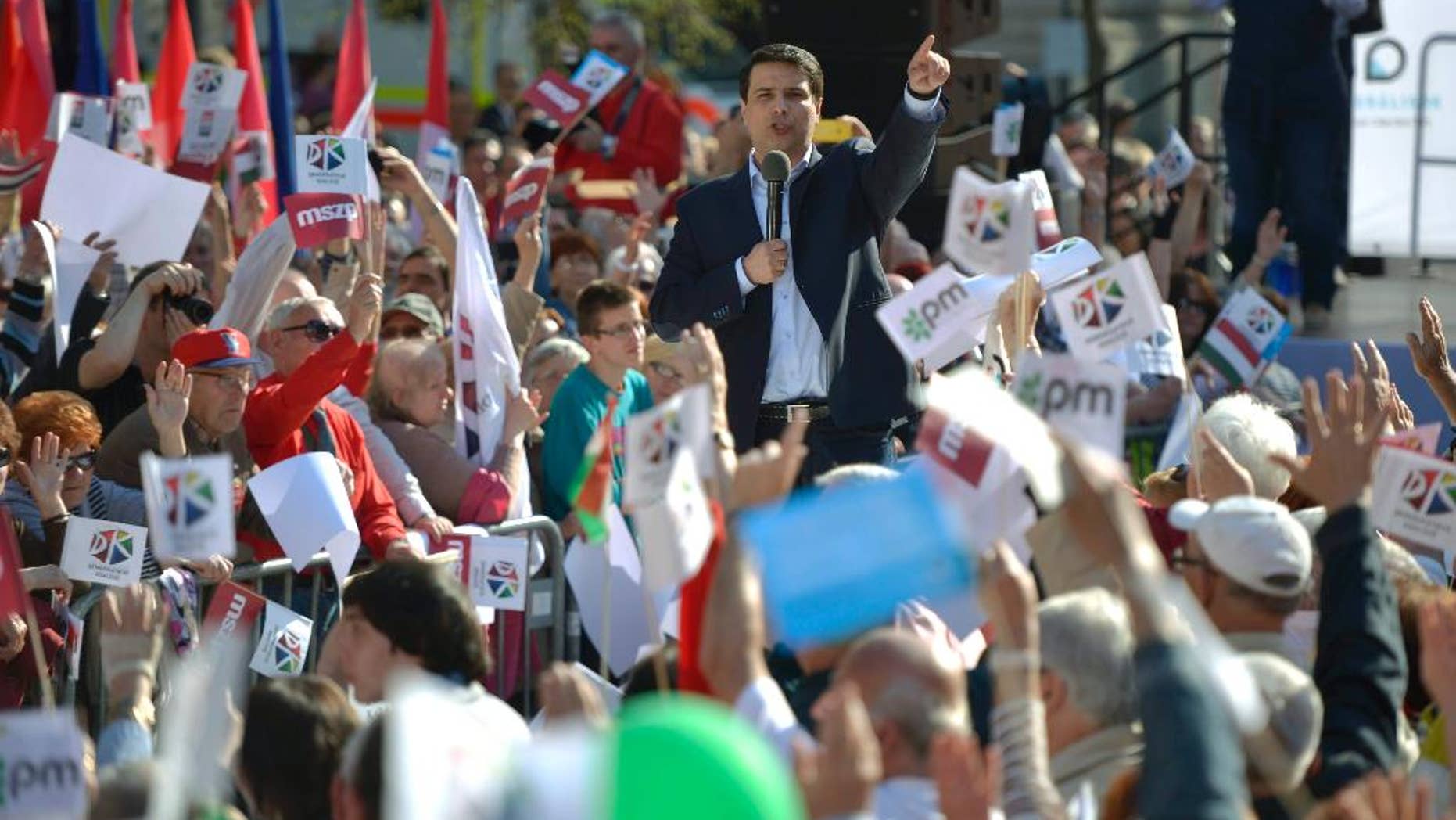 In this Sunday, March 30, 2014 photo, Chairman of the Hungarian Socialist Party and prime minister candidate for the oppositional five-party coalition Attila Mesterhazy addresses the election campaign rally of the centre-left and liberal alliance in front of the Hungarian State Opera in Budapest, Hungary. Polls expect Viktor Orban’s Fidesz and its small ally, the Christian Democrats, to win easily on Sunday and they may even retain the two-thirds majority in the legislature gained in 2010 which allowed them to pass a new constitution, adopt unconventional economic policies, centralize power and grow the state’s influence at the expense of the private sector. Speaking at an election rally Thursday in Gyor, a city in Hungary’s more prosperous west, Orban acknowledged that Fidesz was the favorite but urged an admiring crowd on Szechenyi Square to cast their votes only for his center-right alliance. Polls predict Fidesz will win around 45-50 percent of the votes, while it could be a close race for second between a coalition of five left-wing groups led by Attila Mesterhazy and the Socialist Party - seen getting 25 percent - and the surging far-right Jobbik party which could receive up to 20 percent. (AP Photo/MTI, Laszlo Beliczay)