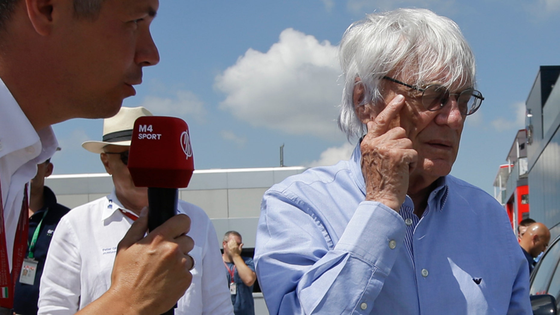 Formula One boss Bernie Ecclestone gesticulates as he answers to a reporter upon his arrival at the Hungaroring racetrack, in Budapest, Hungary, Friday, July 22, 2016. The Hungarian Formula One Grand Prix will be held on Sunday July, 24. (AP Photo/Luca Bruno)