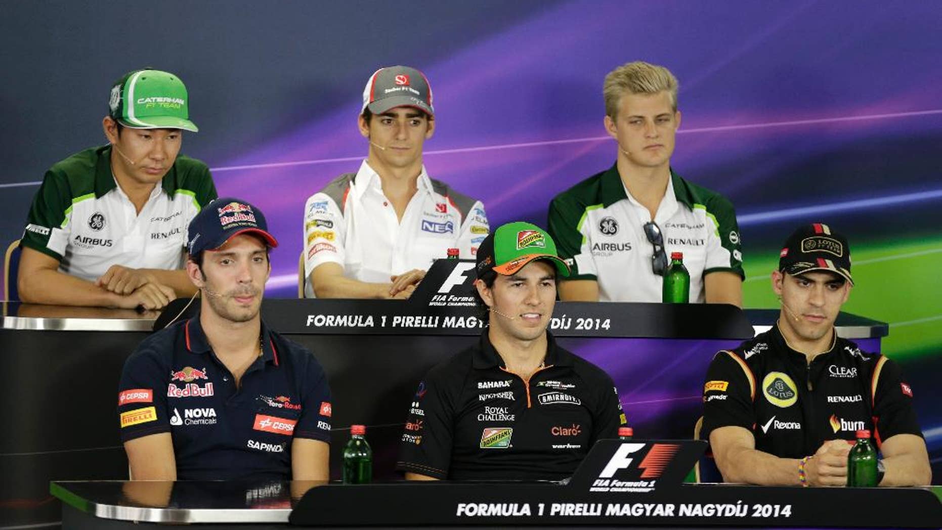 (front row left to right) Scuderia Toro Rosso driver Jean-Eric Vergne of France, Force India driver Sergio Perez of Mexico, Lotus driver Pastor Maldonado of Venezuela, (back row left to right) Caterham driver Kamui Kobayashi of Japan, Sauber driver Esteban Gutierrez of Mexico, Caterham driver Marcus Ericsson of Sweden, attend a press conference at the Hungarian Formula One Grand Prix in Budapest, Hungary, Thursday, July 24, 2014. The Hungarian Grand Prix will be held on Sunday, July 27, 2014. (AP Photo/Petr David Josek)