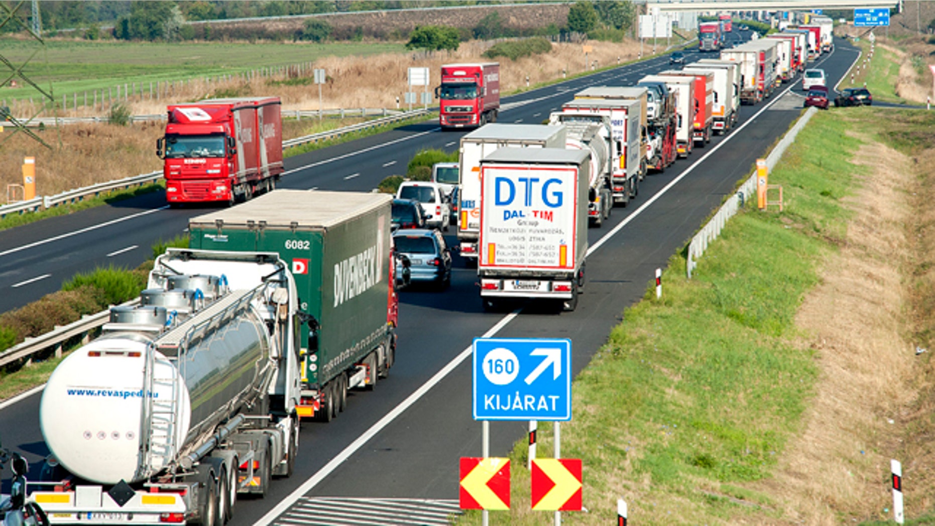 Aug. 31, 2015: A long queue of vehicles waits on the M1 motorway near the border between Hungary and Austria near Mosonmagyarovar, 158 km northwest from Budapest, Hungary. (Csaba Krizsan/MTI via AP)