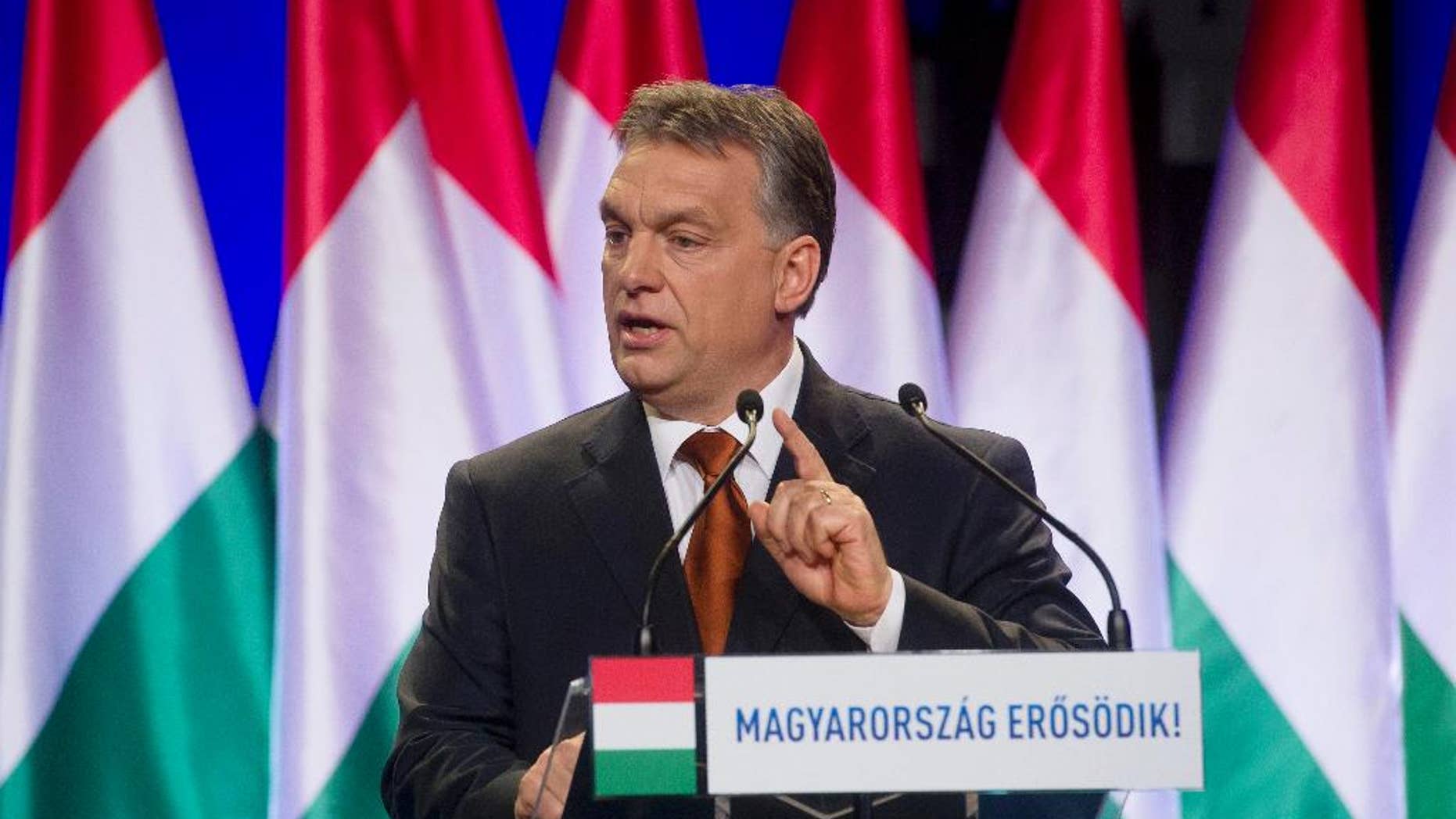 FILE - In this Feb. 27, 2015 file photo Hungarian Prime Minister Viktor Orban delivers his annual "state of the nation" speech in Budapest, Hungary. A debate about restoring the death penalty has been a recurring issue with Orban since a 2002 bank robbery in which eight people were murdered. The inscription reads: "Hungary Grows Stronger". (Szilard Koszticsak/MTI via AP, File)