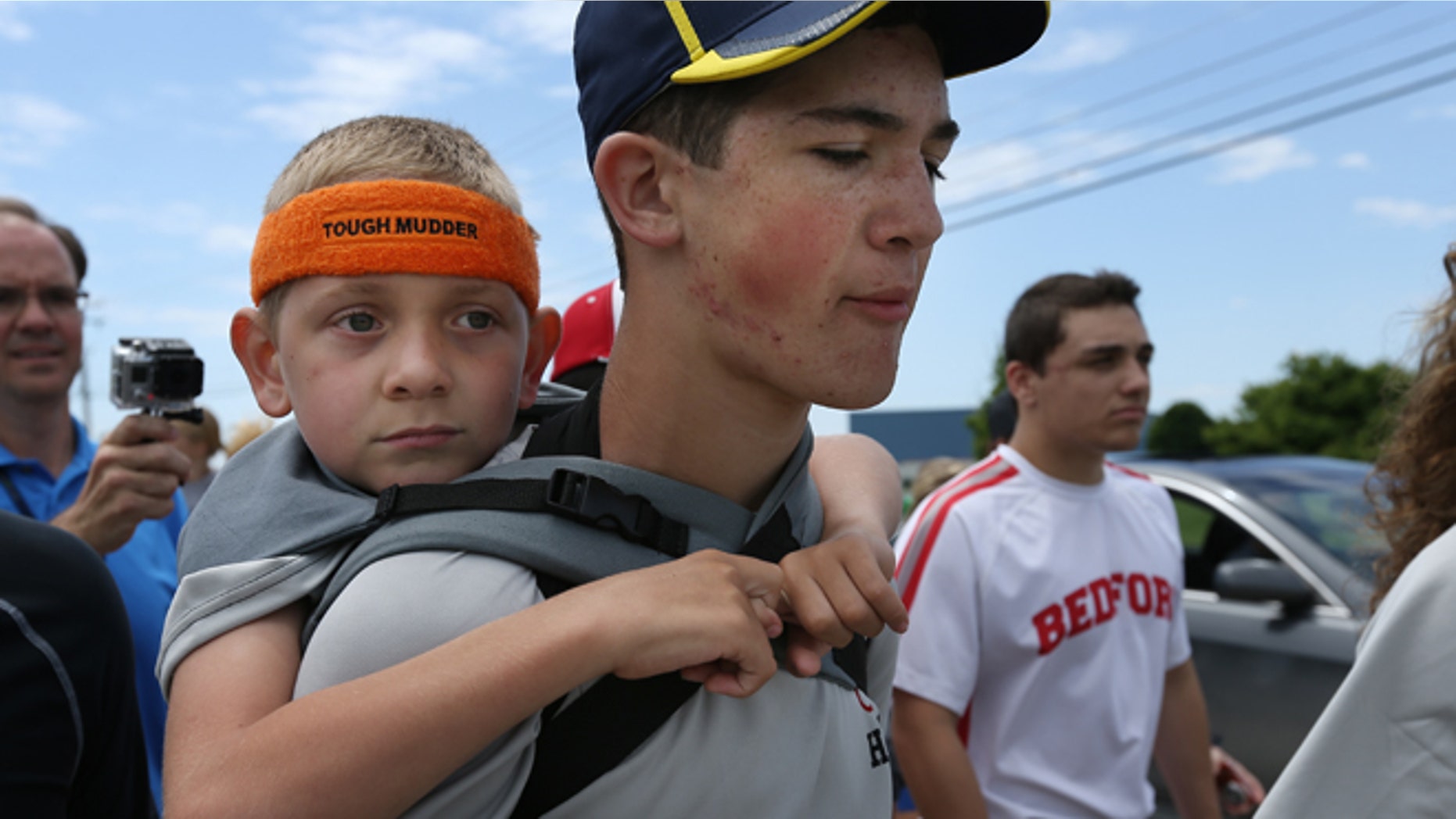 June 8, 2014: Braden Gandee, 7, rides on his brother Hunter's, 14, shoulders as they close in on the final miles to the University of Michigan Bahna Wrestler Center. Hunter carried Braden, who has cerebral palsy, 40 miles from Bedford, Mich. to Ann Arbor, Mich.
