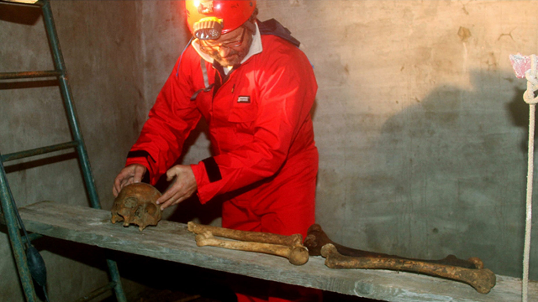 Italian researcher Antonio Moretti collects bones on a wooden board inside the crypt of San Sebastiano cemetery, in Porto Ercole, Italy. Moretti and a team of fellow scientists and academics want to solve the mystery surrounding the death of one of Italy's greatest artists: Caravaggio.