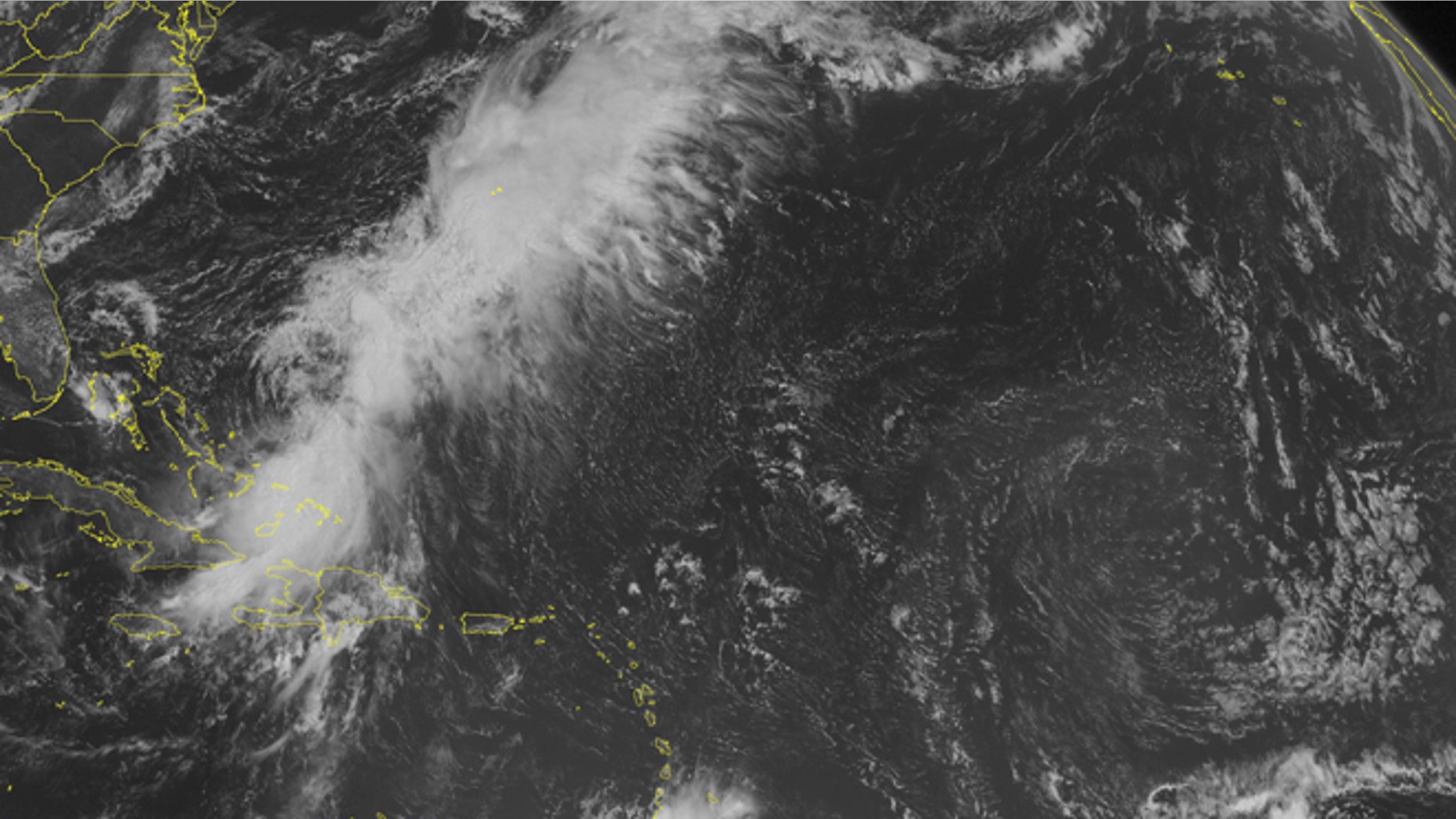 This NOAA satellite image taken Monday, Aug. 25, 2014, at 10:45 a.m. EDT shows Tropical Storm Cristobal affecting the southeastern Bahamas, far eastern Cuba and Hispaniola. Most of the shower activity associated with the system was far-re moved from the center of circulation, indicating a sheared and possibly weakening system. Meanwhile, widespread shower and thunderstorm activity was streaming to the northeast of the tropical system, along a stationary frontal boundary draped through the Atlantic. A weak tropical wave was producing thunderstorms over the southern Lesser Antilles, as well. (AP Photo/Weather Underground)