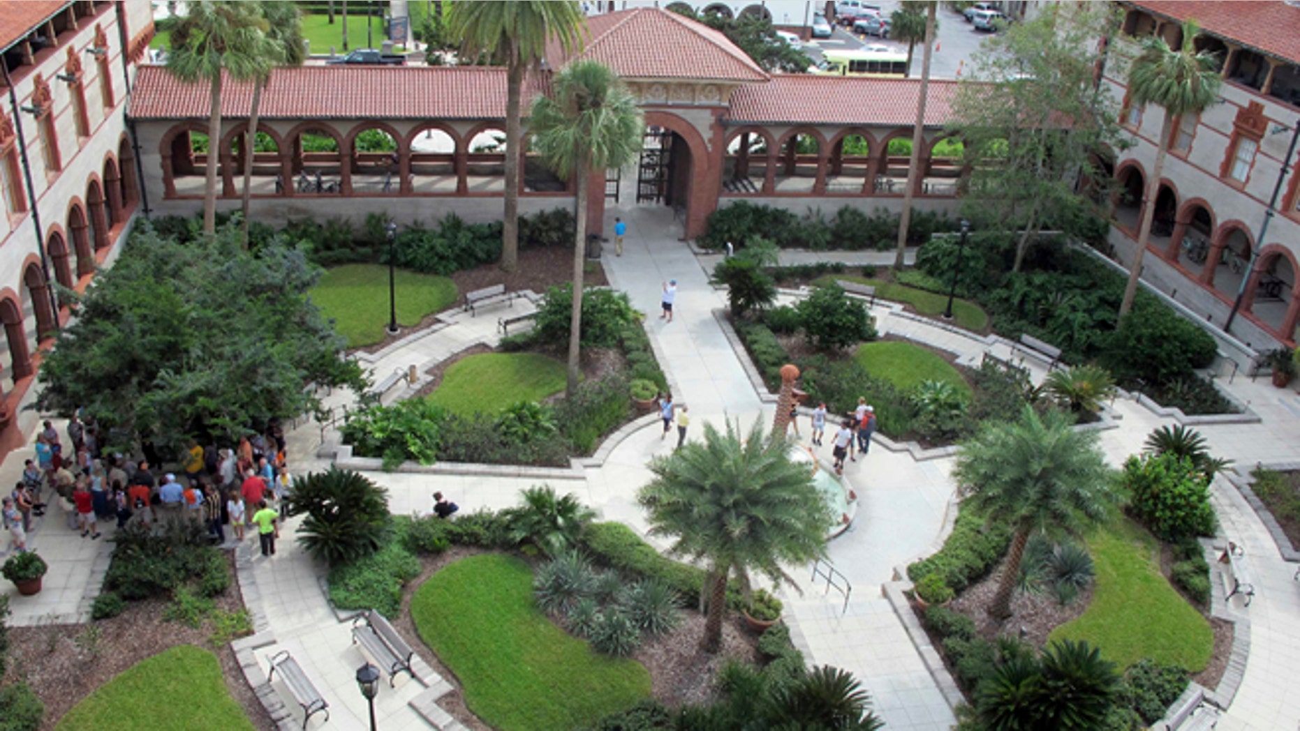 In this photo taken Oct. 28, 2016, people gather in the courtyard of Flagler College in St. Augustine, Fla. The building constructed in 1888, a registered national landmark, was flooded by 3-to-4-feet of storm surge during Hurricane Matthew. More than 1,000 students were evacuated prior to the storm, but the school managed to reopen a week after the storm passed. (AP Photo/Jason H. Dearen)
