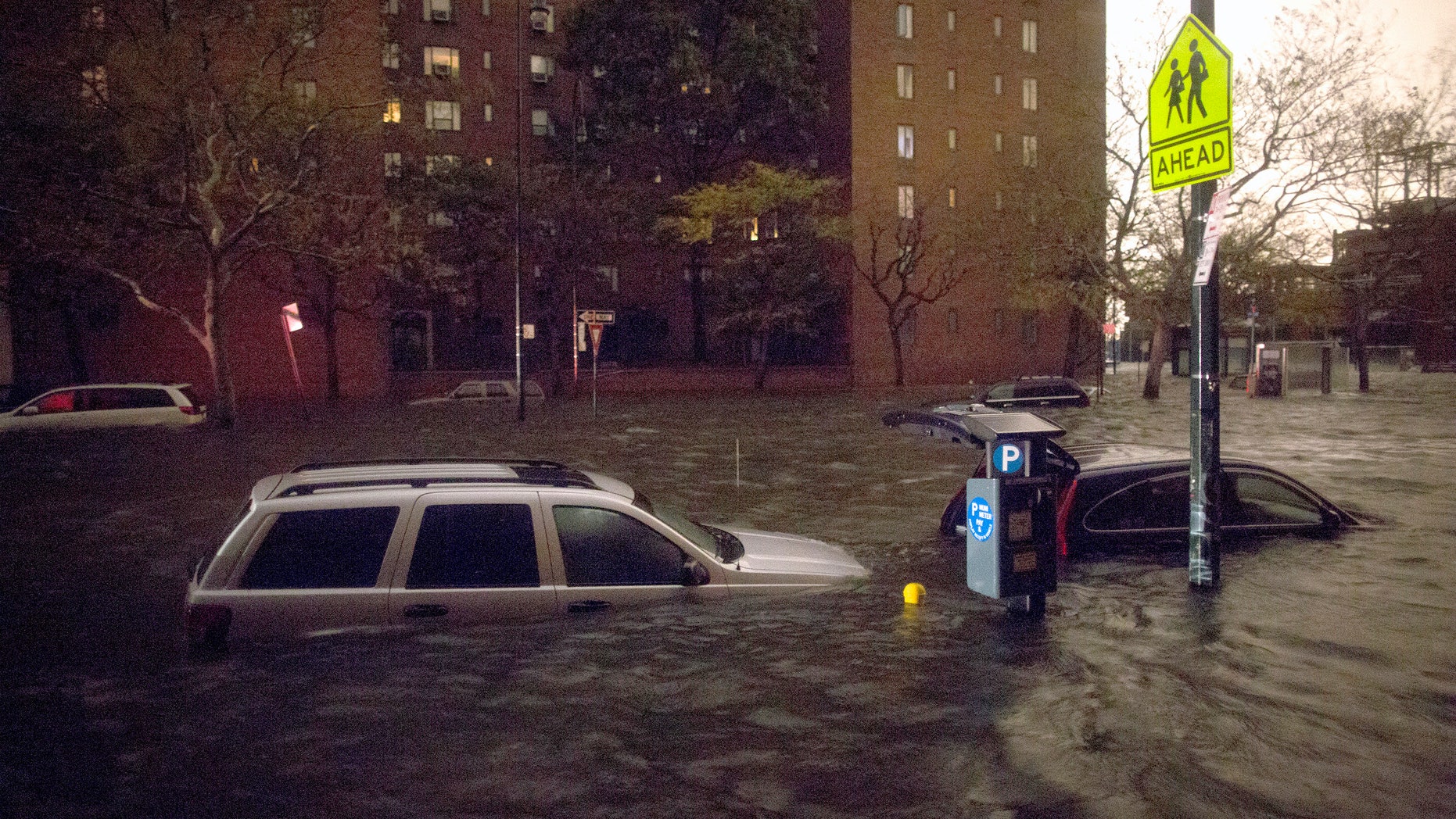 Vehicles are submerged on 14th Street near the Consolidated Edison power plant, Monday, Oct. 29, 2012, in New York. (AP Photo/ John Minchillo)