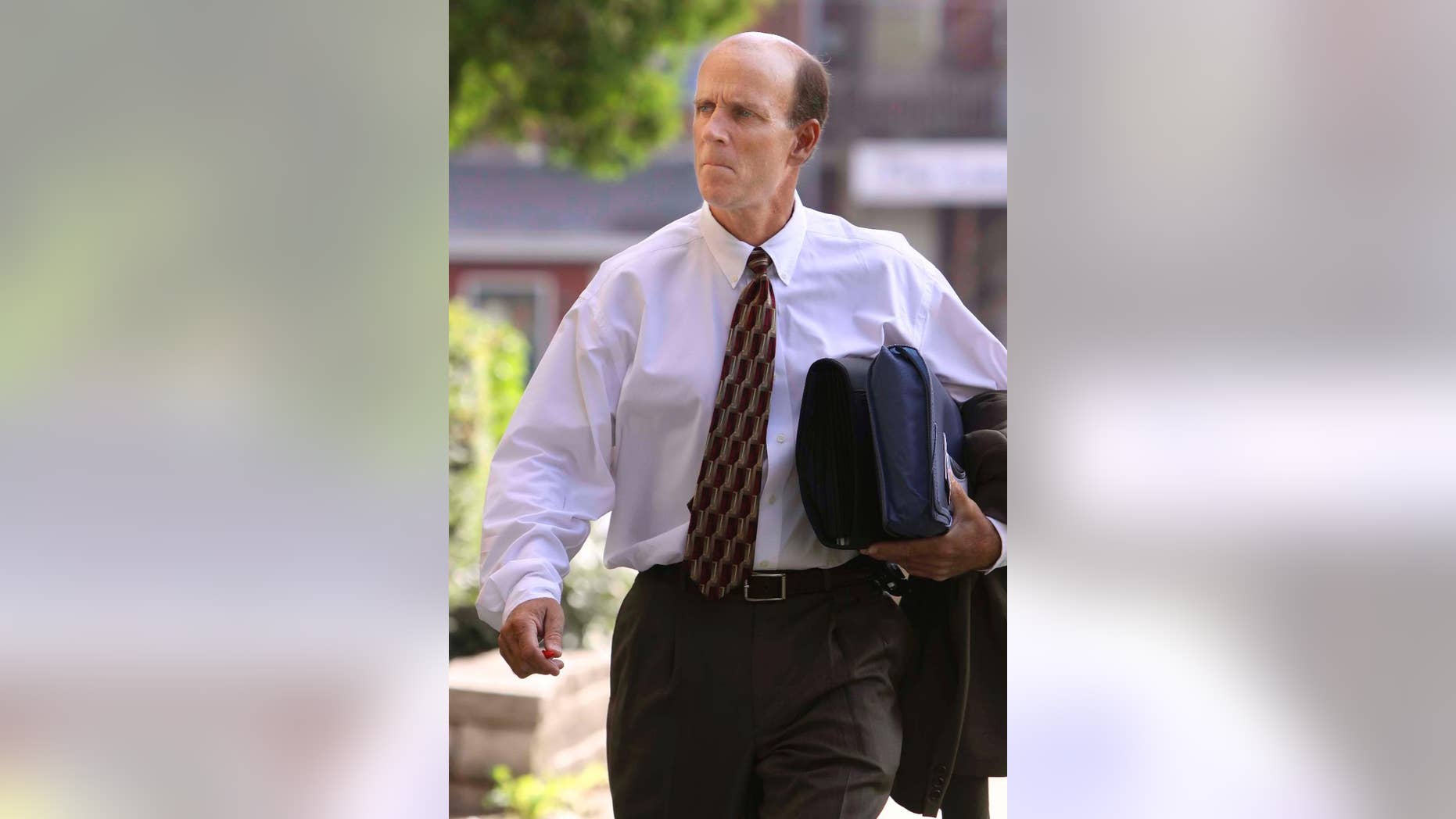 FILE - In this Wednesday July 15, 2009 file photo, defendant Calvin Harris heads to Tioga County Court in Owego, N.Y. On Friday, May 15, 2015 a judge declared a mistrial in the murder case against Harris with two previous convictions for killing his estranged wife, Michele, in the hours after the Sept. 11 terrorist attacks. (Jeff Richards/The Star-Gazette via AP, Pool)