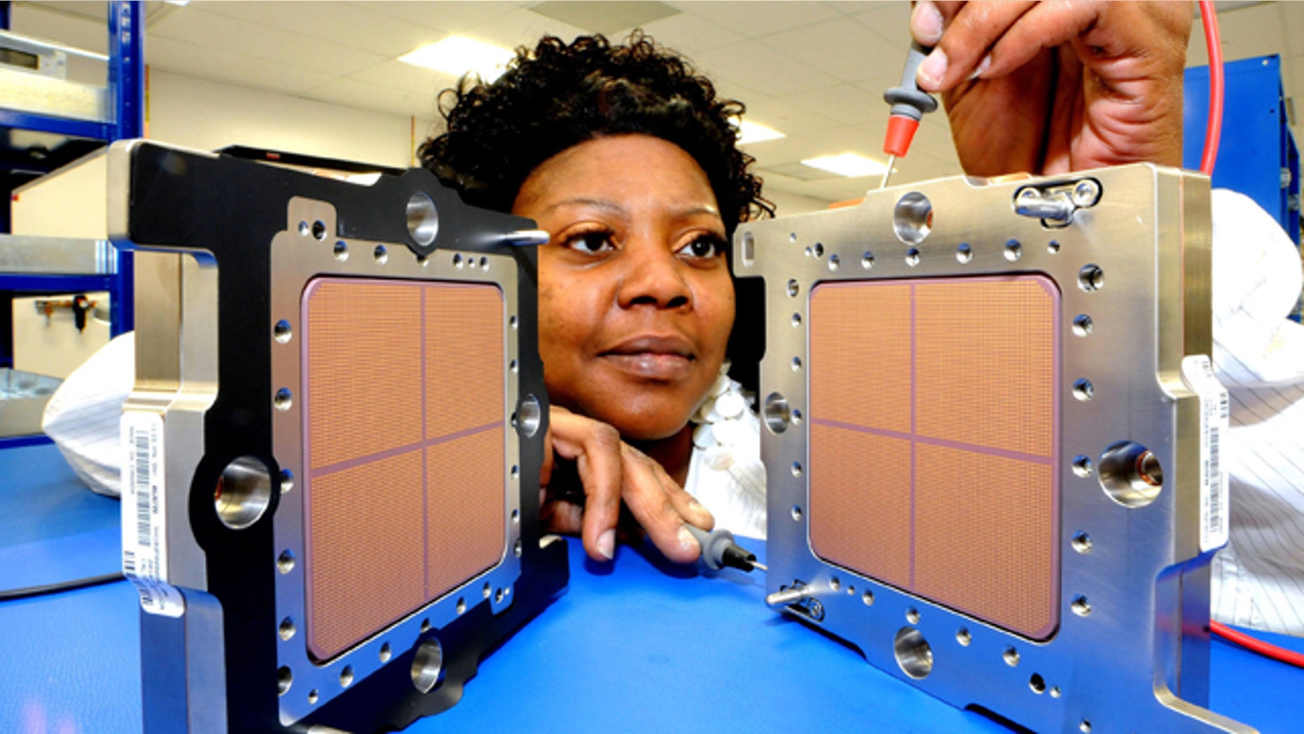 IBM technician Asia Dent tests the world's fastest microprocessor, made in New York and shipping to clients on Sept. 10. The heart of IBM's new zEnterprise System mainframes, the new chip helps deliver world-record speeds of 5.2 GHz.
