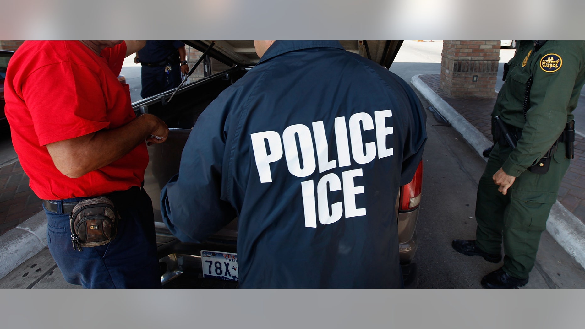 HIDALGO, TX - MAY 28: Special agents from Immigration and Customs Enforcement (ICE), Border Patrol, and Customs and Border Protection (CBP) question a man while his vehicle is searched after he was stopped heading into Mexico at the Hidalgo border crossing on May 28, 2010 in Hidalgo, Texas. The inspection was part of a Department of Homeland Security (DHS) joint effort between ICE, CBP and Customs and Border Patrol. The organizations are trying to slow the flow of guns, money and drugs from the United State into Mexico. (Photo by Scott Olson/Getty Images)