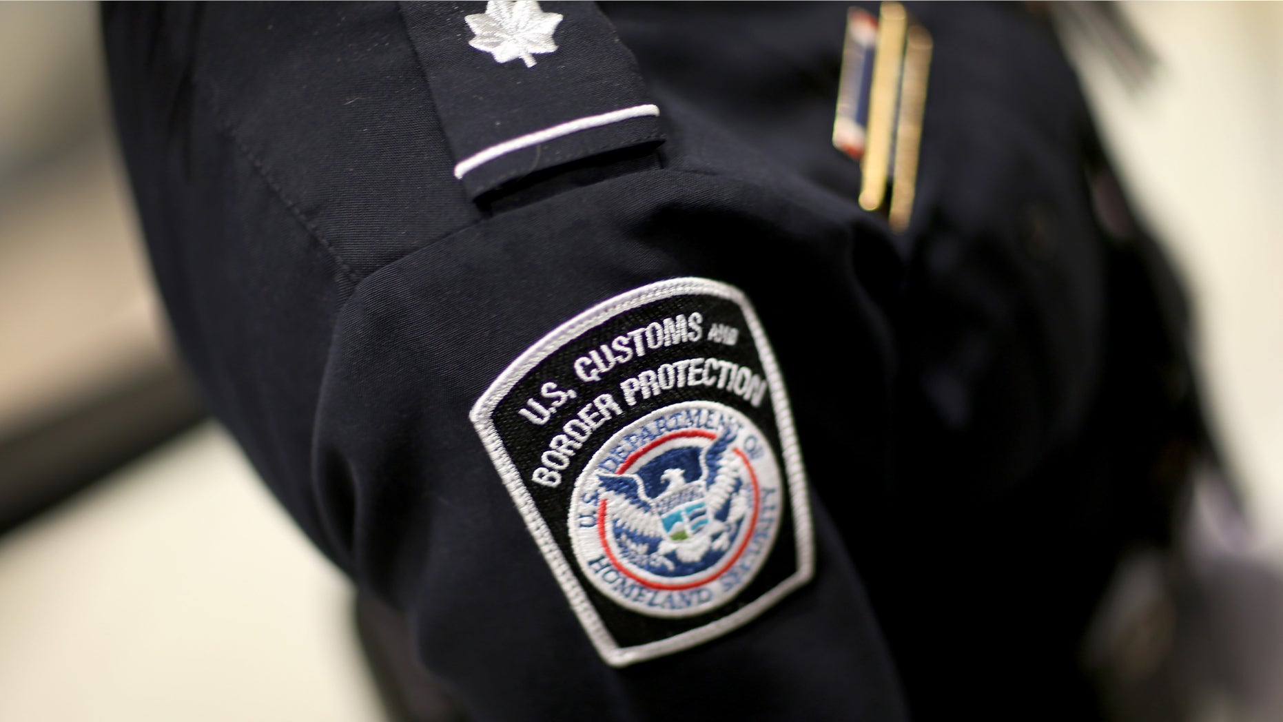 MIAMI, FL - MARCH 04: A U.S. Customs and Border Protection officer's patch is seen as they unveil a new mobile app for international travelers arriving at Miami International Airport on March 4, 2015 in Miami, Florida. Miami-Dade Aviation Department and U.S. Customs and Border Protection (CBP) unveiled a new mobile app for expedited passport and customs screening. The app for iOS and Android devices allows U.S. citizens and some Canadian citizens to enter and submit their passport and customs declaration information using their smartphone or tablet and to help avoid the long waits in the exit lanes. (Photo by Joe Raedle/Getty Images)