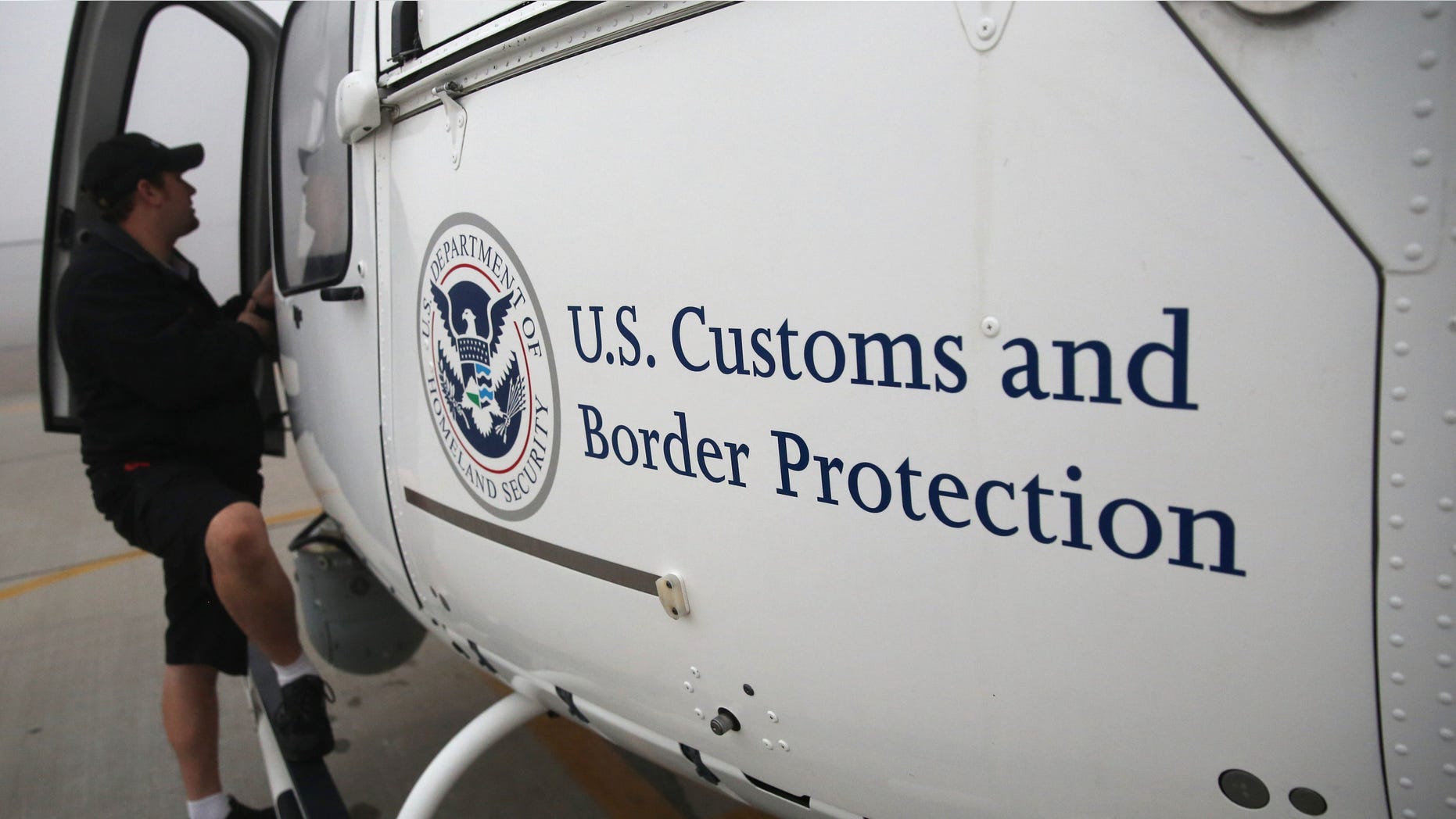 SAN DIEGO, CA - OCTOBER 01: A maintenance worker prepares a U.S. Office of Air and Marine (OAM) helicopter for takeoff to patrol the U.S.-Mexico border on October 1, 2013 in San Diego, California. OAM helicopters support the U.S. Border Patrol as well as Immigration and Customs Enforcement (ICE), personnel protecting border areas. While much of the Federal Government has closed down, personnel considered essential, such as border agents, remain working. (Photo by John Moore/Getty Images)