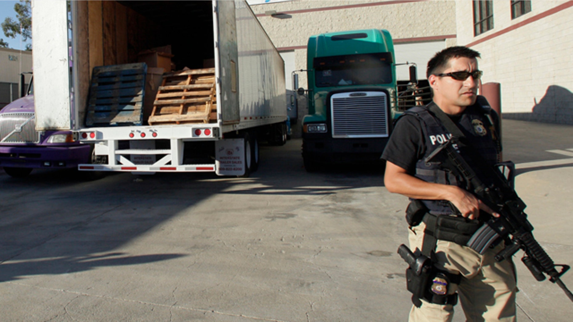 Nov. 3, 2010: John Morton, left, the Director of Immigration and Customs Enforcement inspects a bundle of marijuana with Joe Garcia, assistant agent in charge for Homeland Security Investigations, at a warehouse along the border between the United States and Mexico.