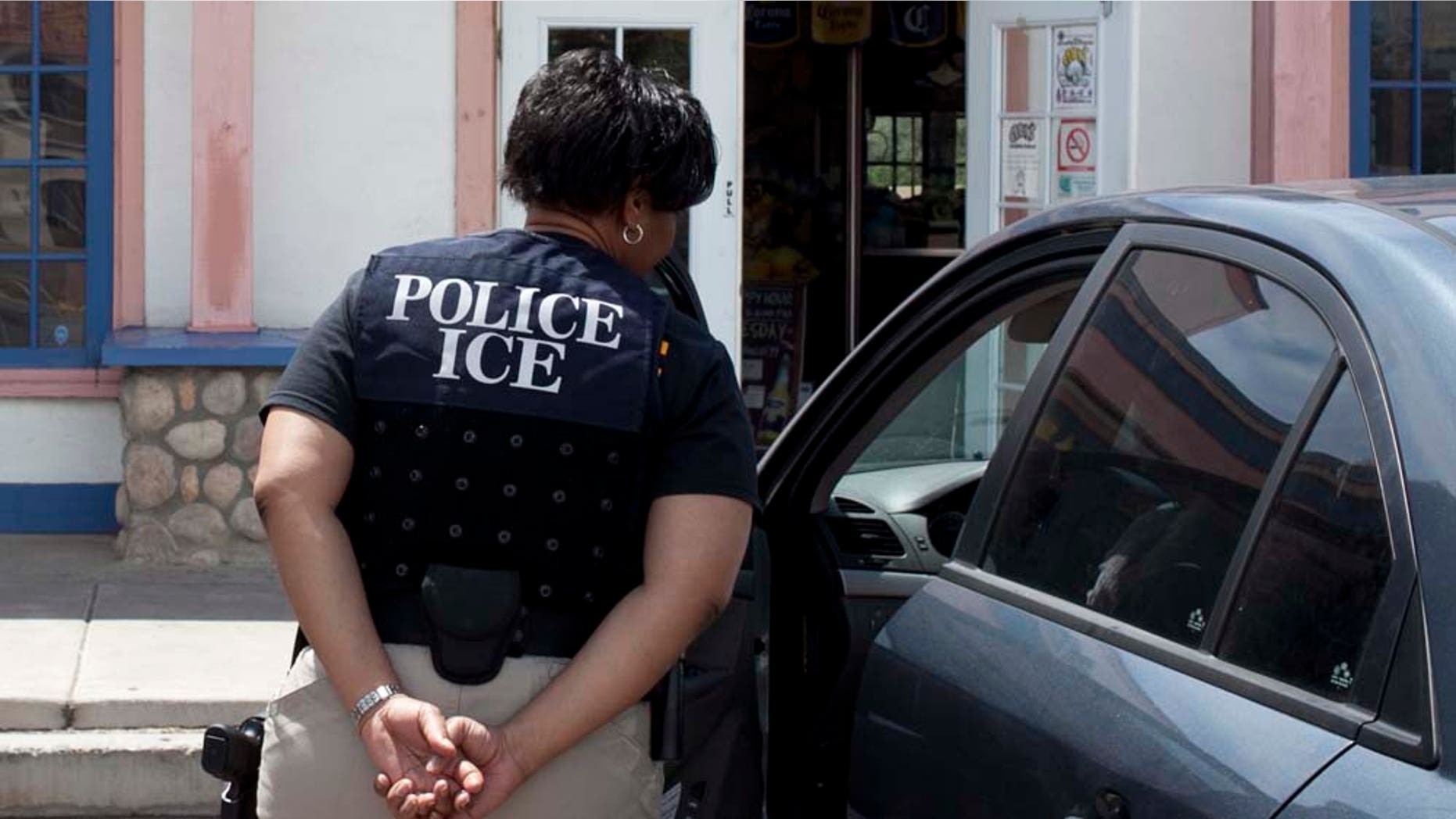 An ICE officer tells a customer that the Chuy's restaurant at 1831 East Baseline Road, in Tempe, Ariz., is closed because of an on-going investigation, Wednesday, April 20, 2011. The owners of the restaurant chain with outlets in Arizona and California have been indicted on suspicion of hiring illegal immigrants and tax evasion. (AP Photo/The Arizona Republic, Mark Henle) MARICOPA COUNTY OUT; MAGS OUT; NO SALES