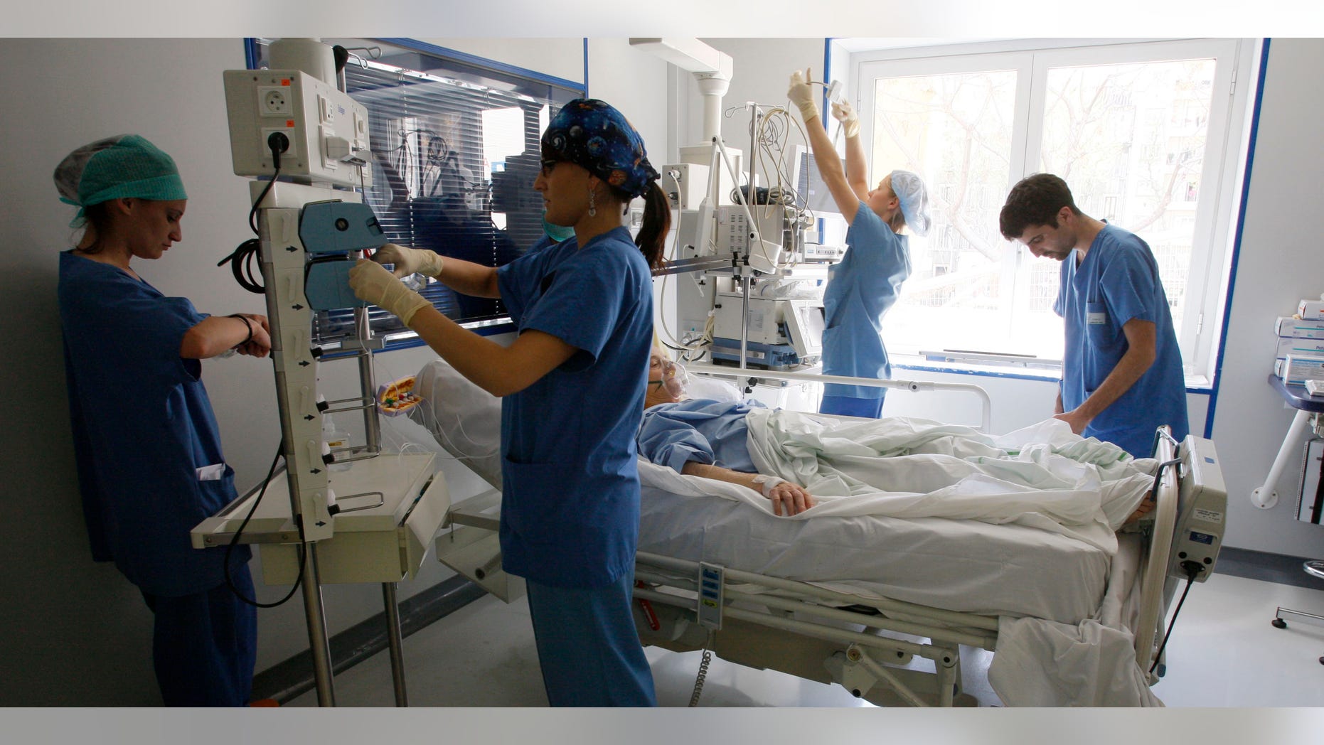Nurses check a patient in the intensive care unit.